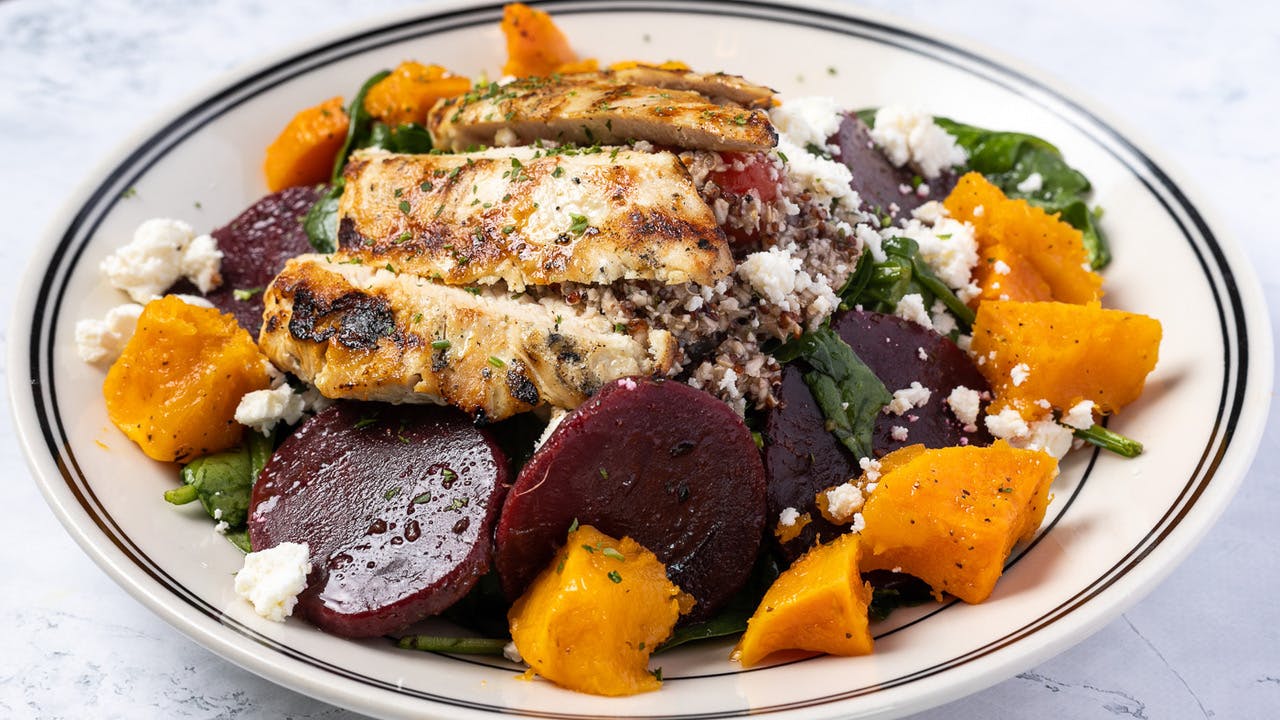 a plate of food with rice meat and vegetables