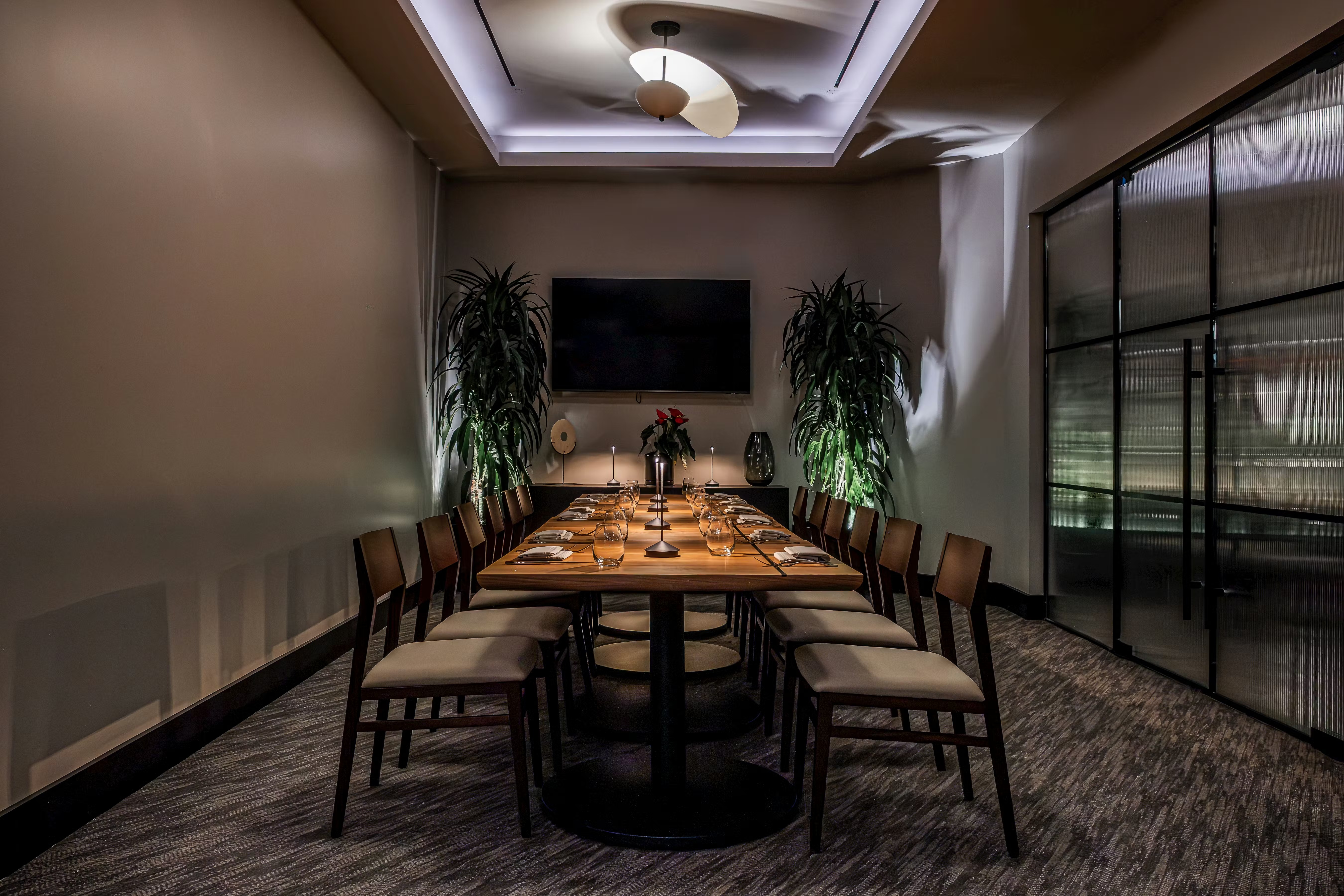 a table with chairs and a television on the wall