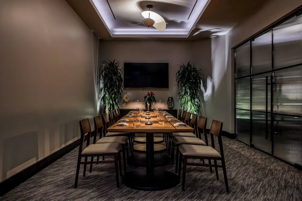a table with chairs and a television on the wall