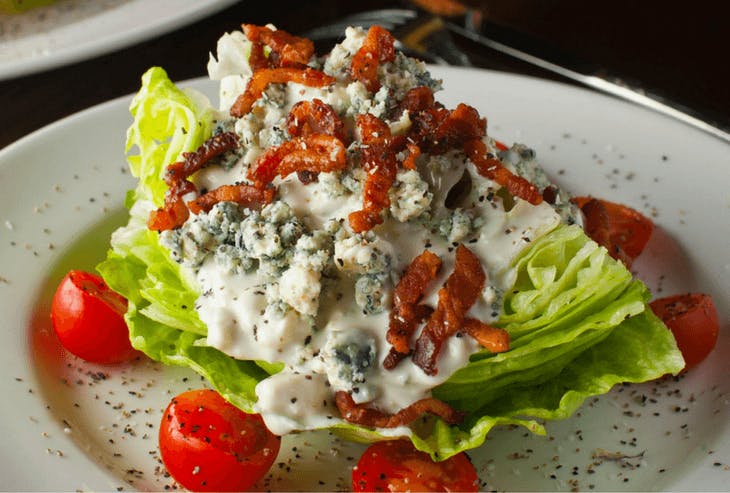 a salad topped with dressing and vegetables