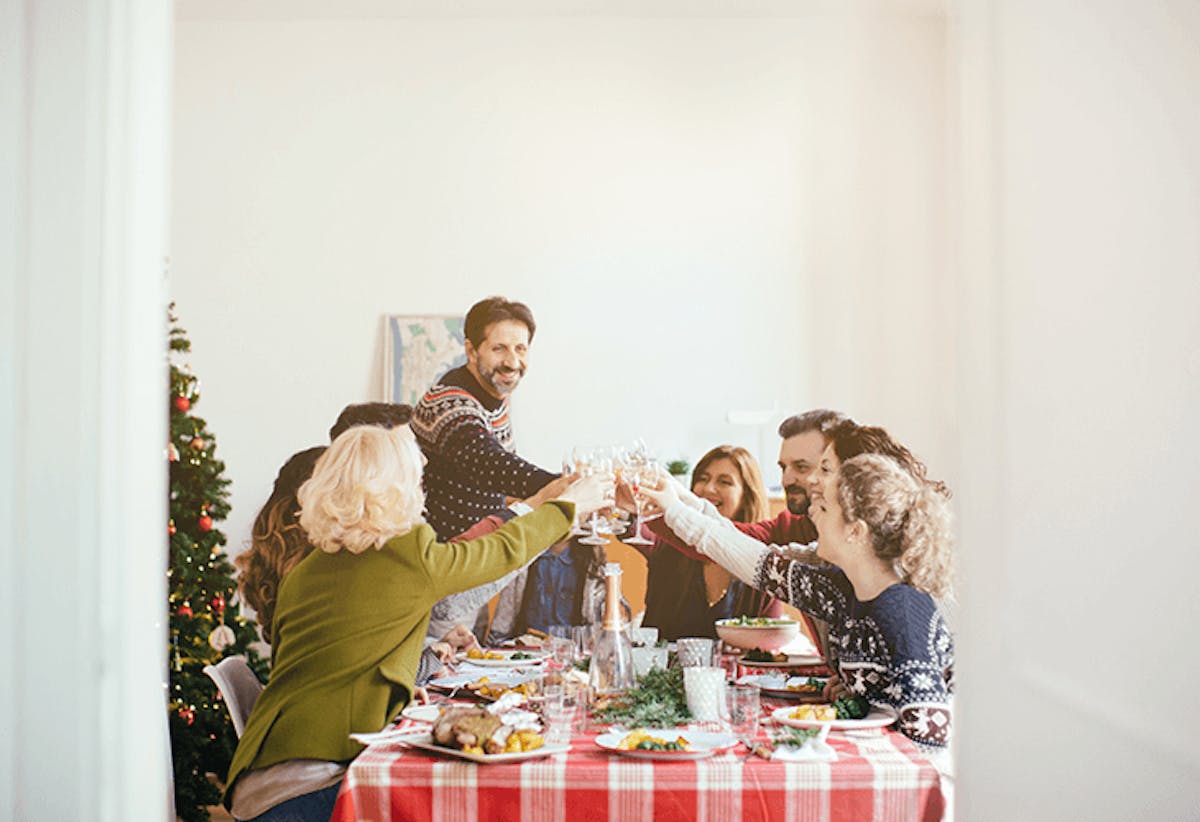 a group of people standing around a table