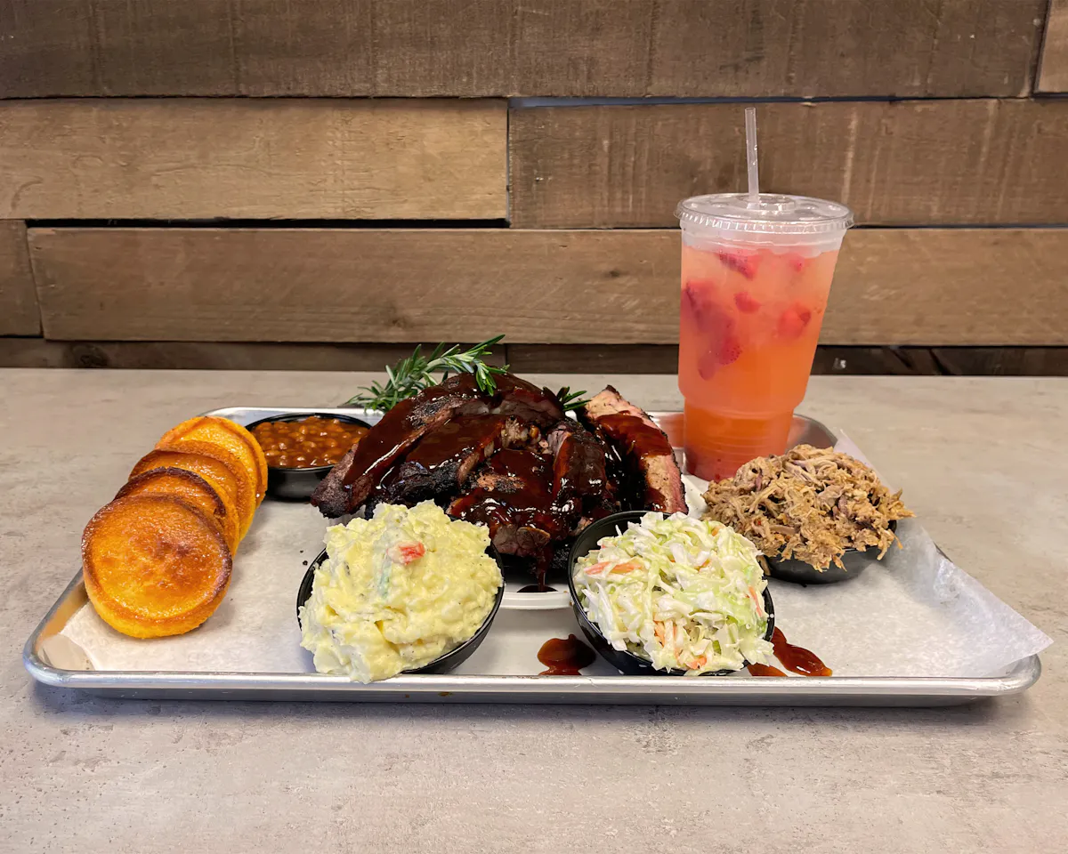 plate of food and an orange drink