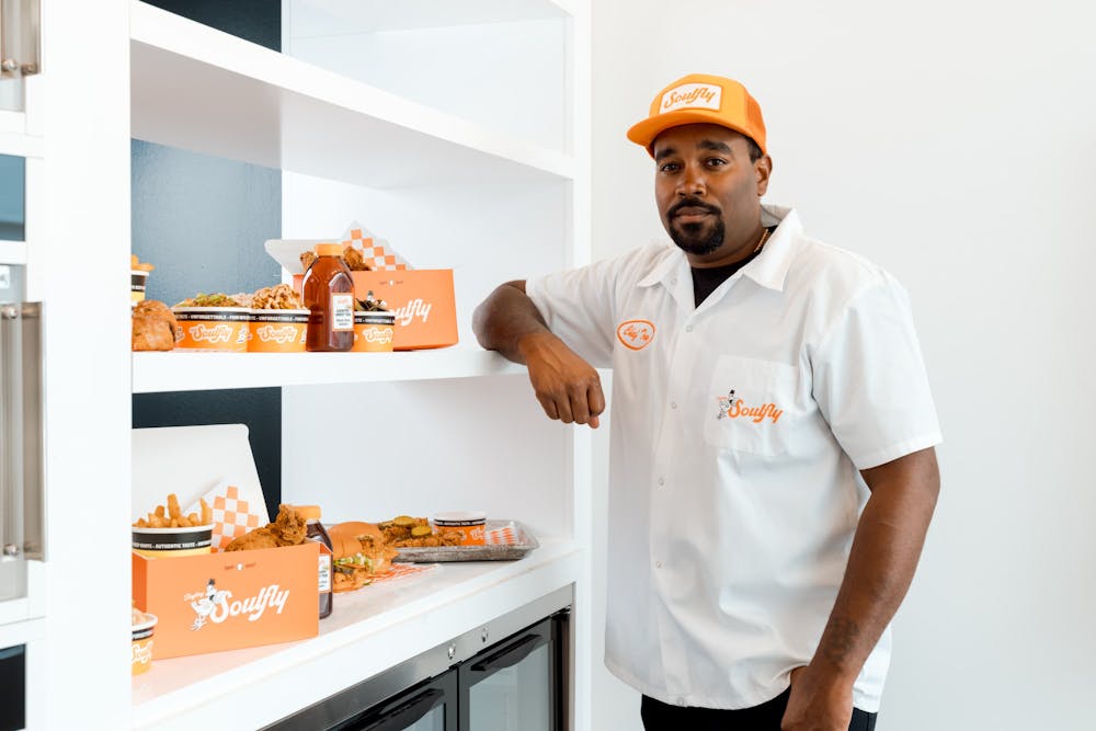 a man standing in a kitchen preparing food