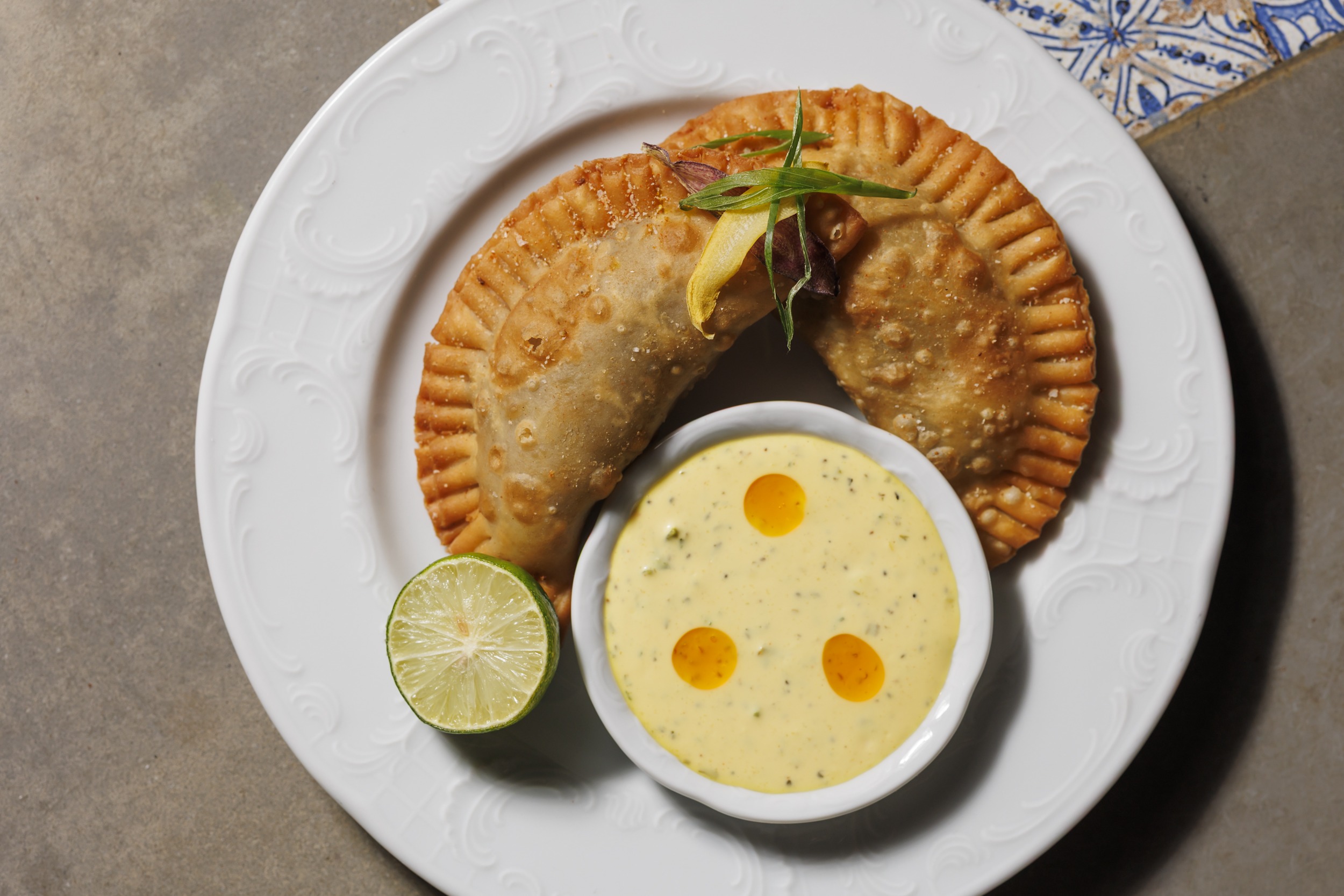 Pork Empanadas  Roast pork, sweet ham, queso, mustard, marrón, salsa del frente