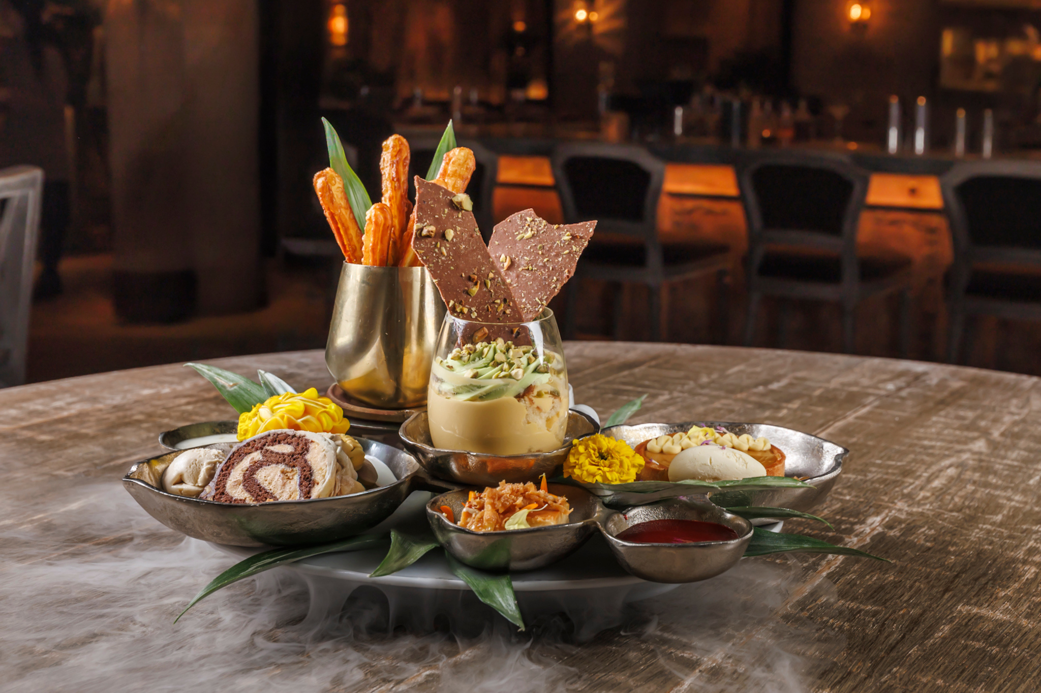 Flashdance**  (Serves 4-8) Tropical tres leches+pistachio whip, rum doughnuts sticks, Cuban coffee cheesecake, cuban lunch roll, mango tartlet, ice cream sandwich, smoke & magic