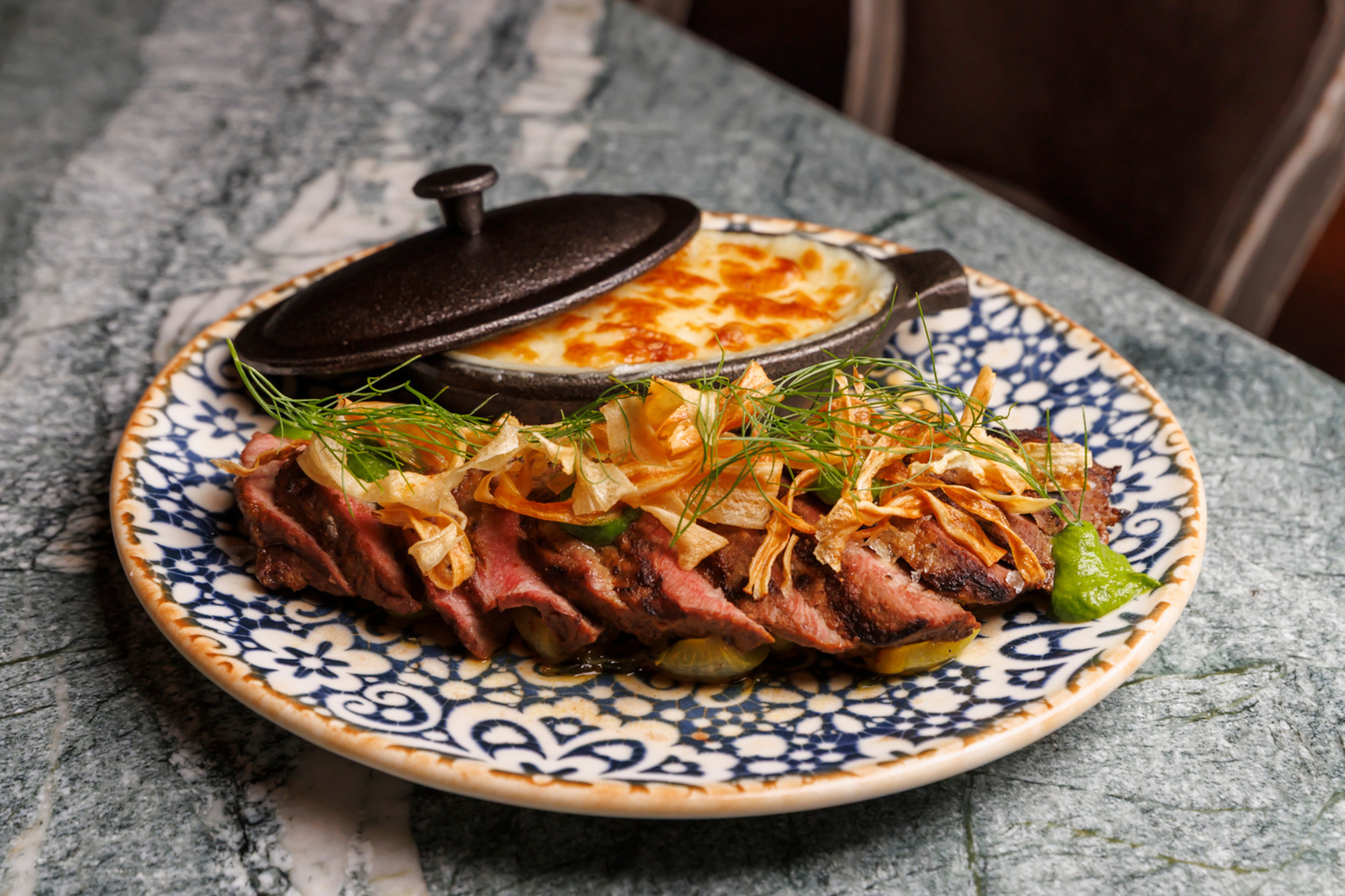 Steak Churrasco*  Prime flat iron steak, provoleta pommes puree, melted cipollini, salsa verde