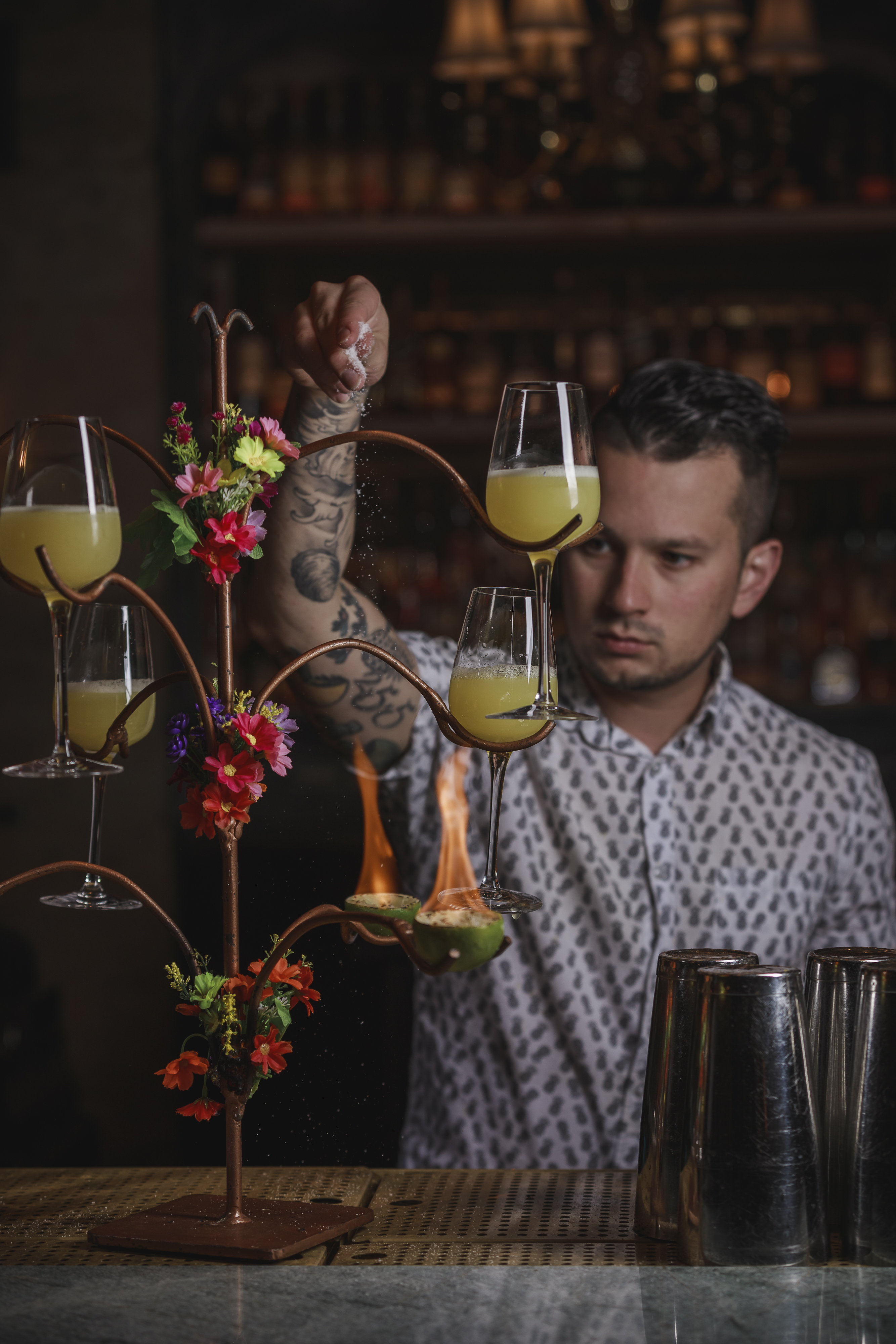 a person holding a vase of flowers on a table