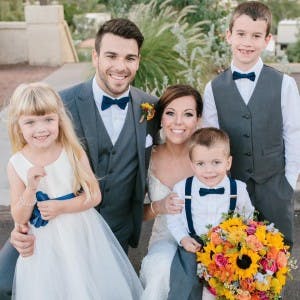 a couple posing for the camera with children