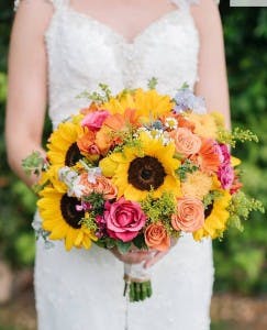 a person holding a bouquet  of flowers