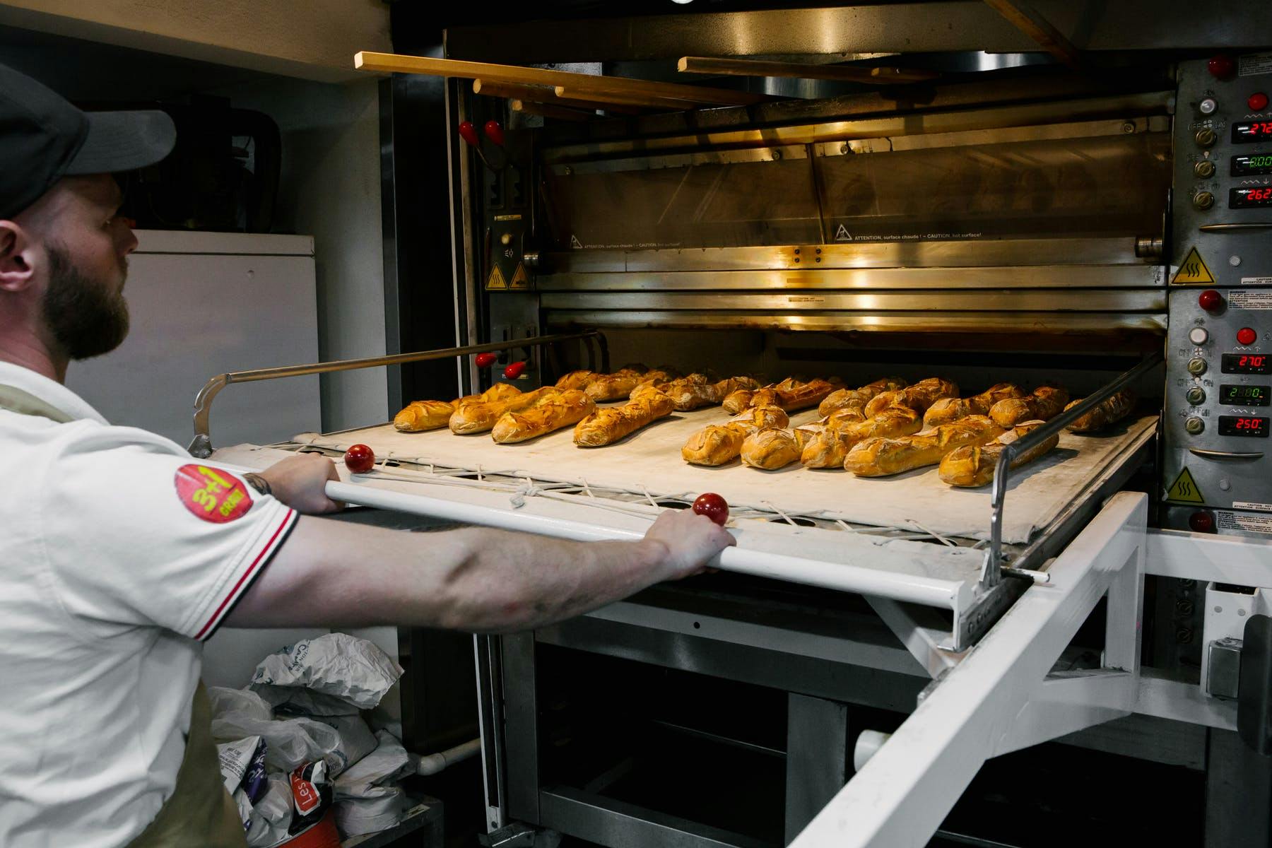 a man standing in front of an oven