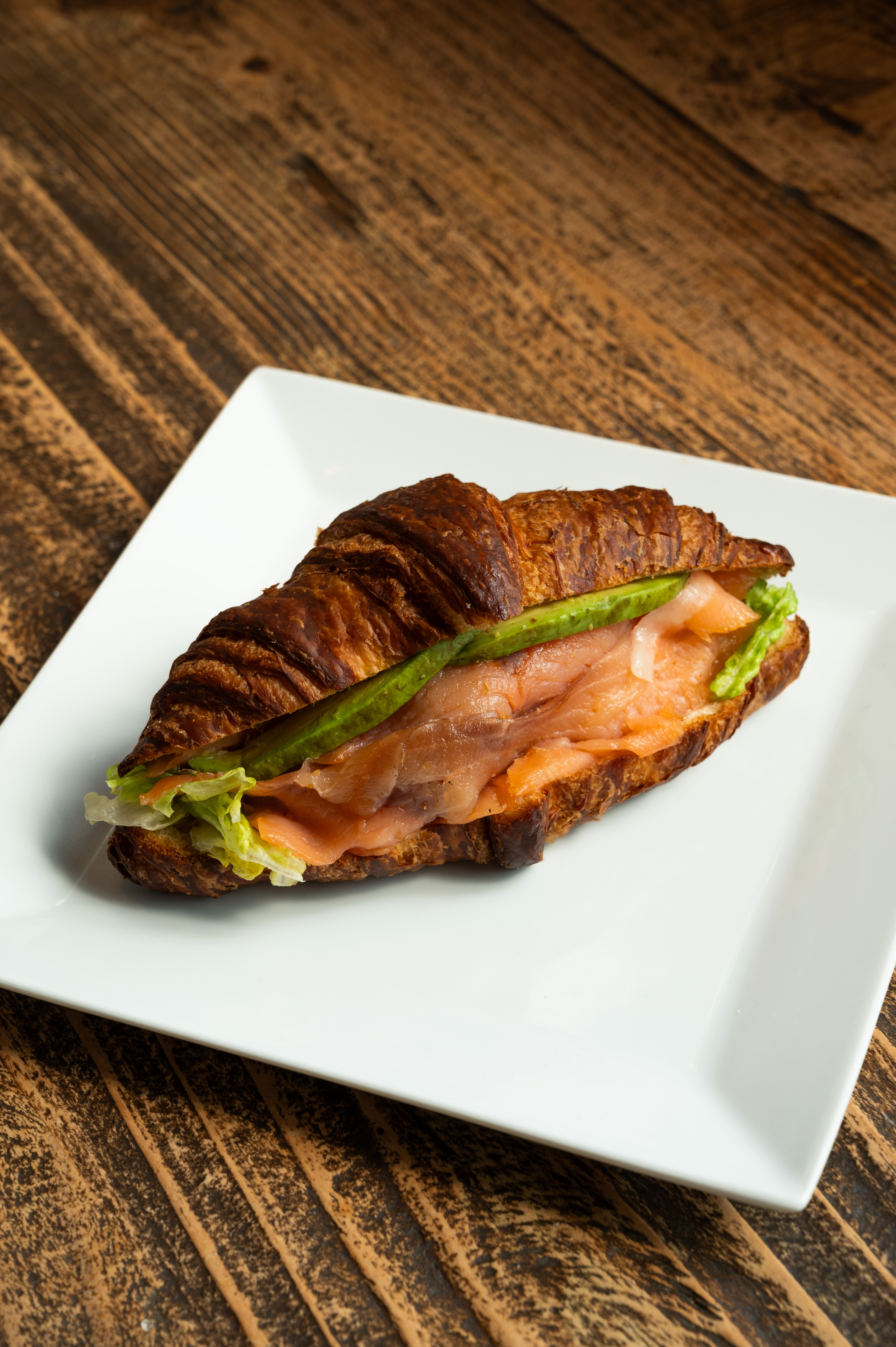 a sandwich sitting on top of a wooden table