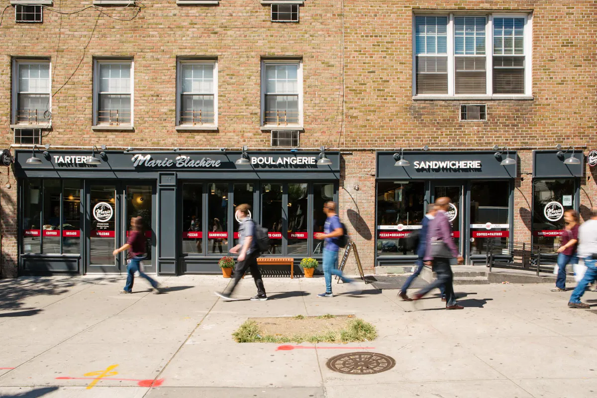 a group of people walking in front of a building