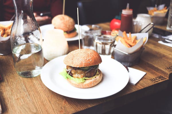 a table topped with burgers