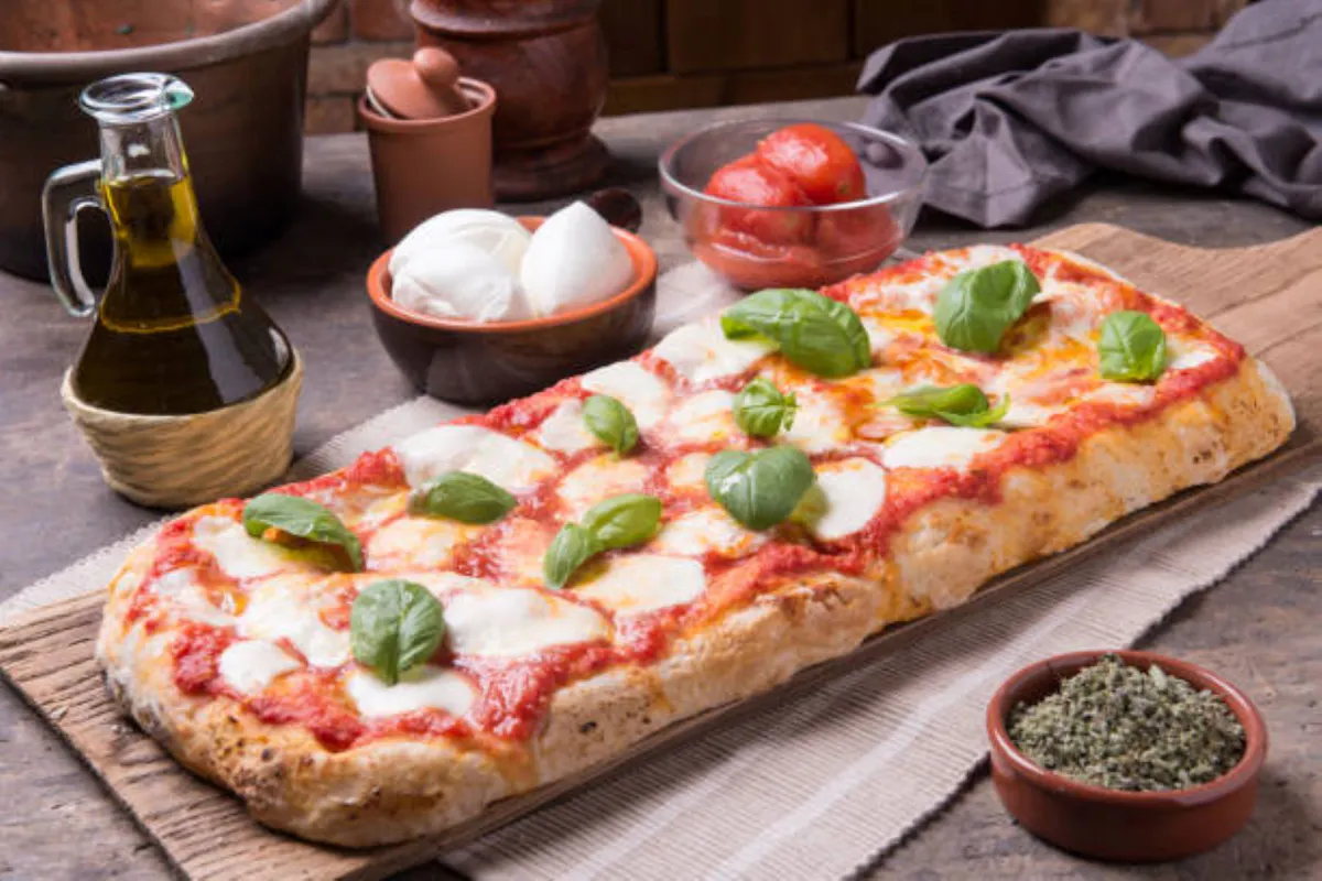 a pizza sitting on top of a wooden table