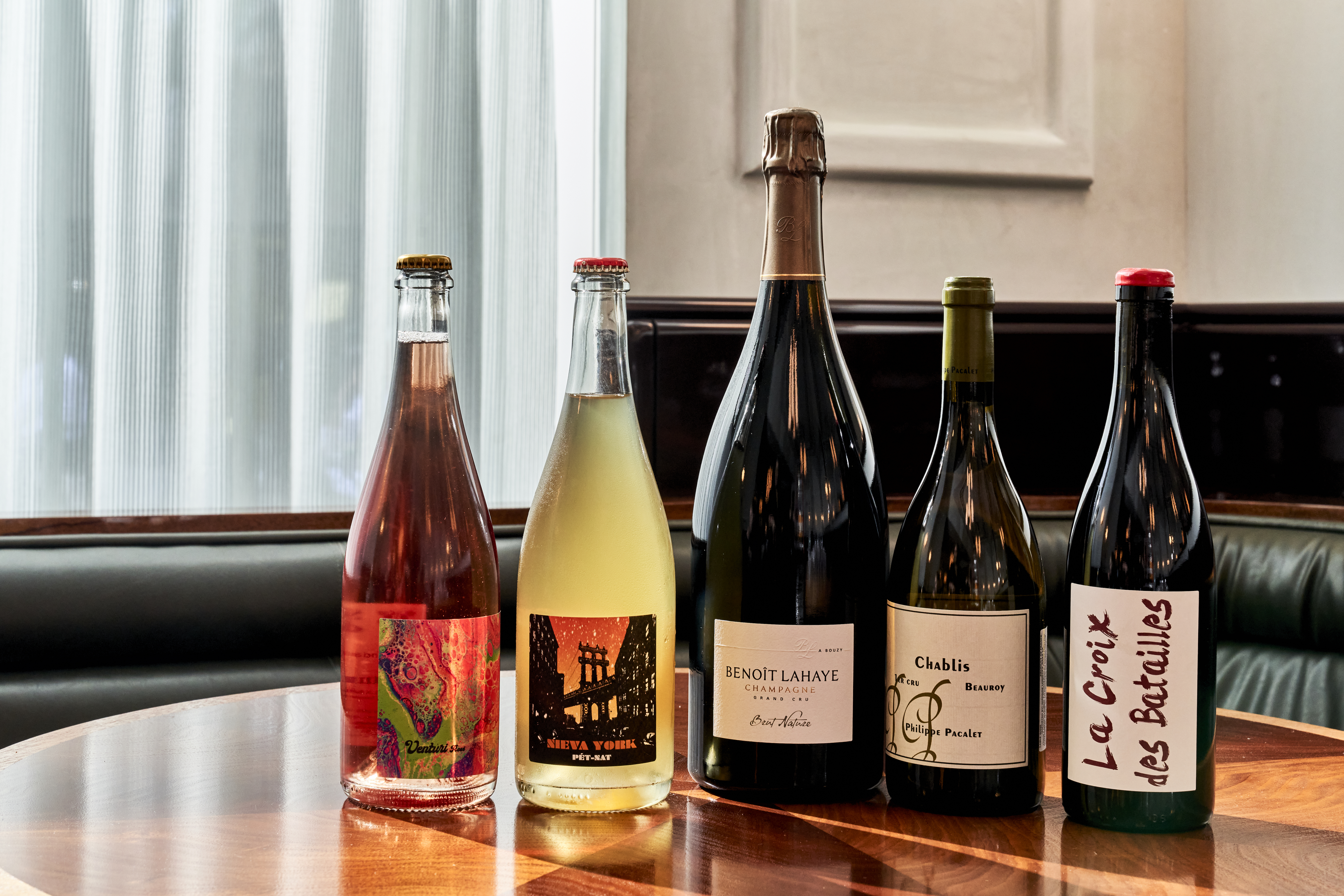 a bottle of wine and a glass of beer on a table