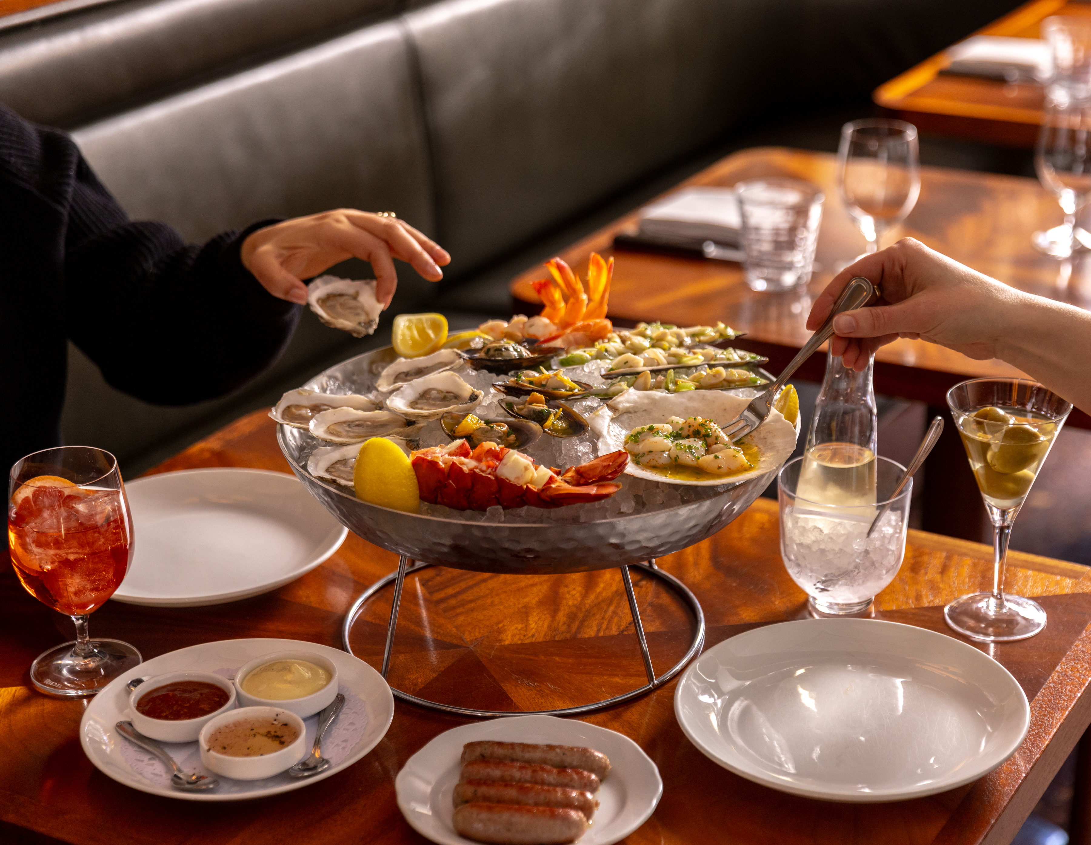 a person sitting at a table with wine glasses