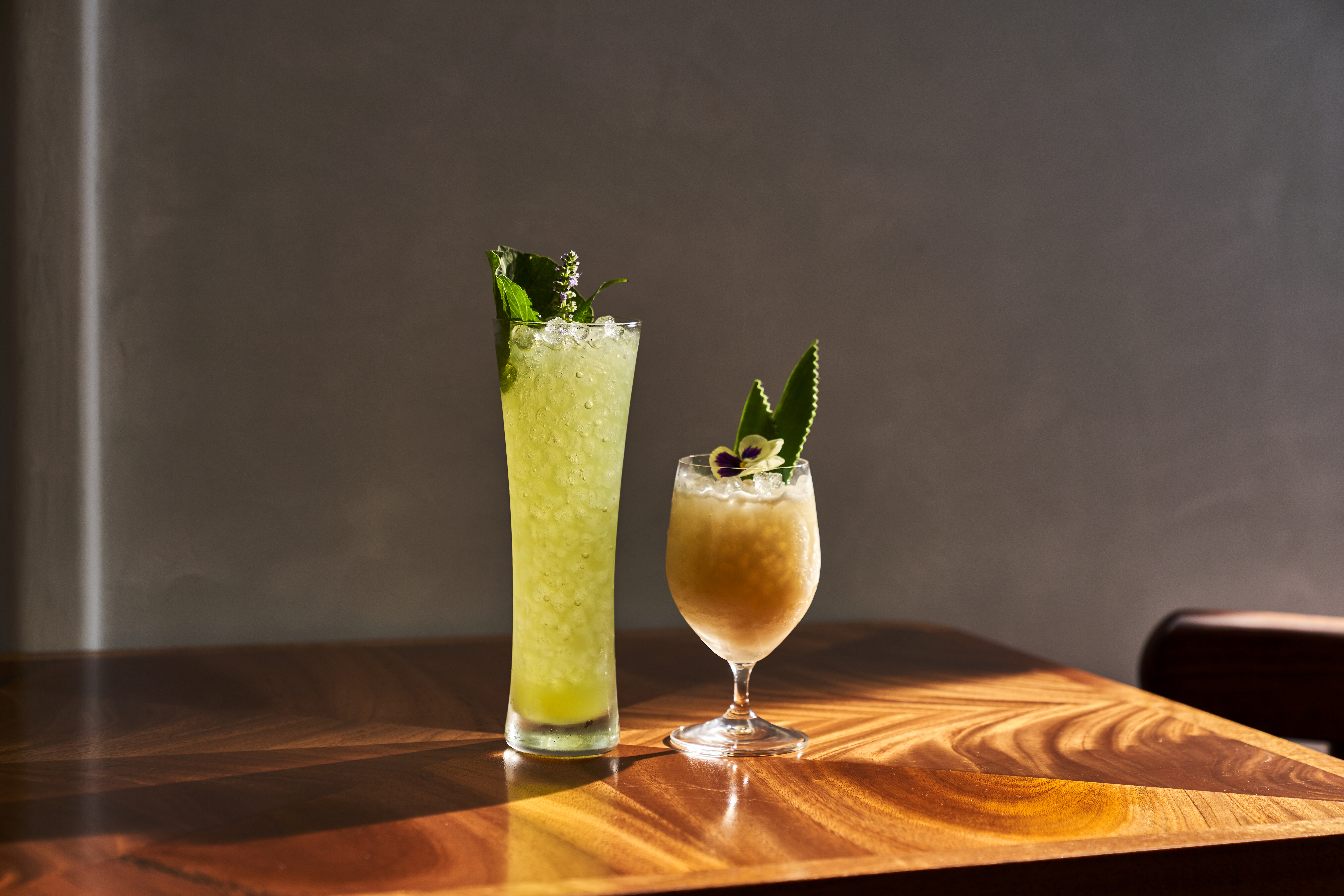 a glass of wine sitting on top of a wooden table