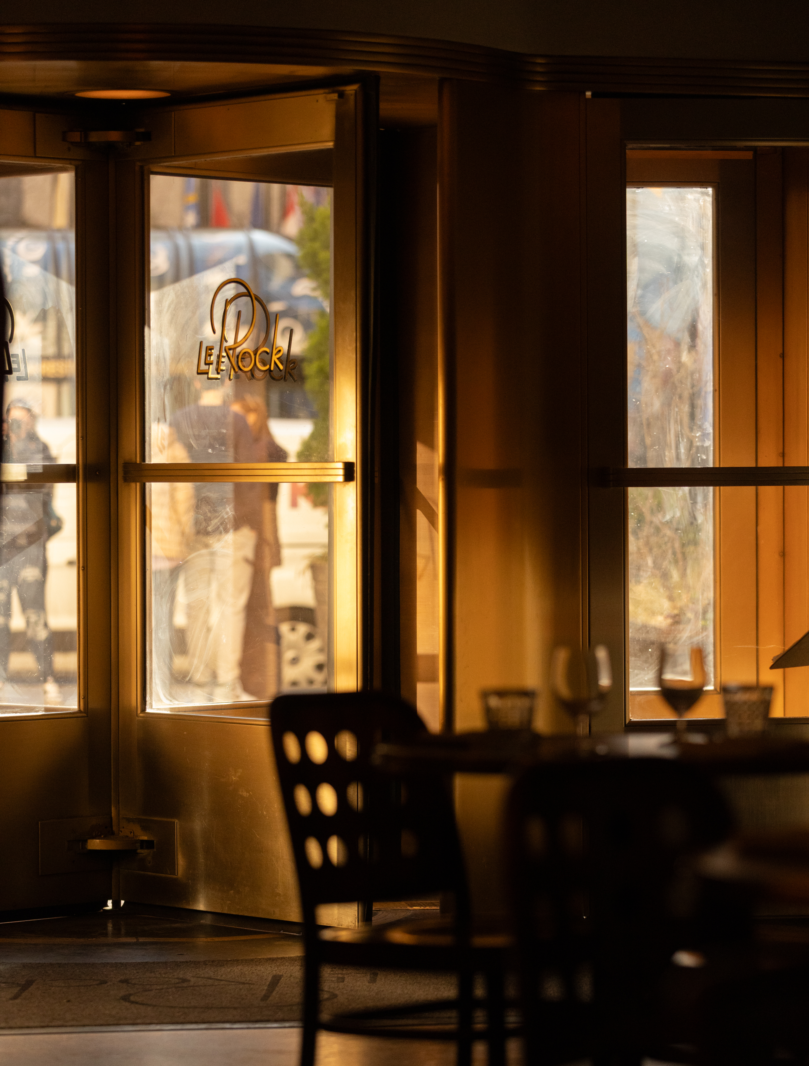 a group of people sitting at a table in front of a window