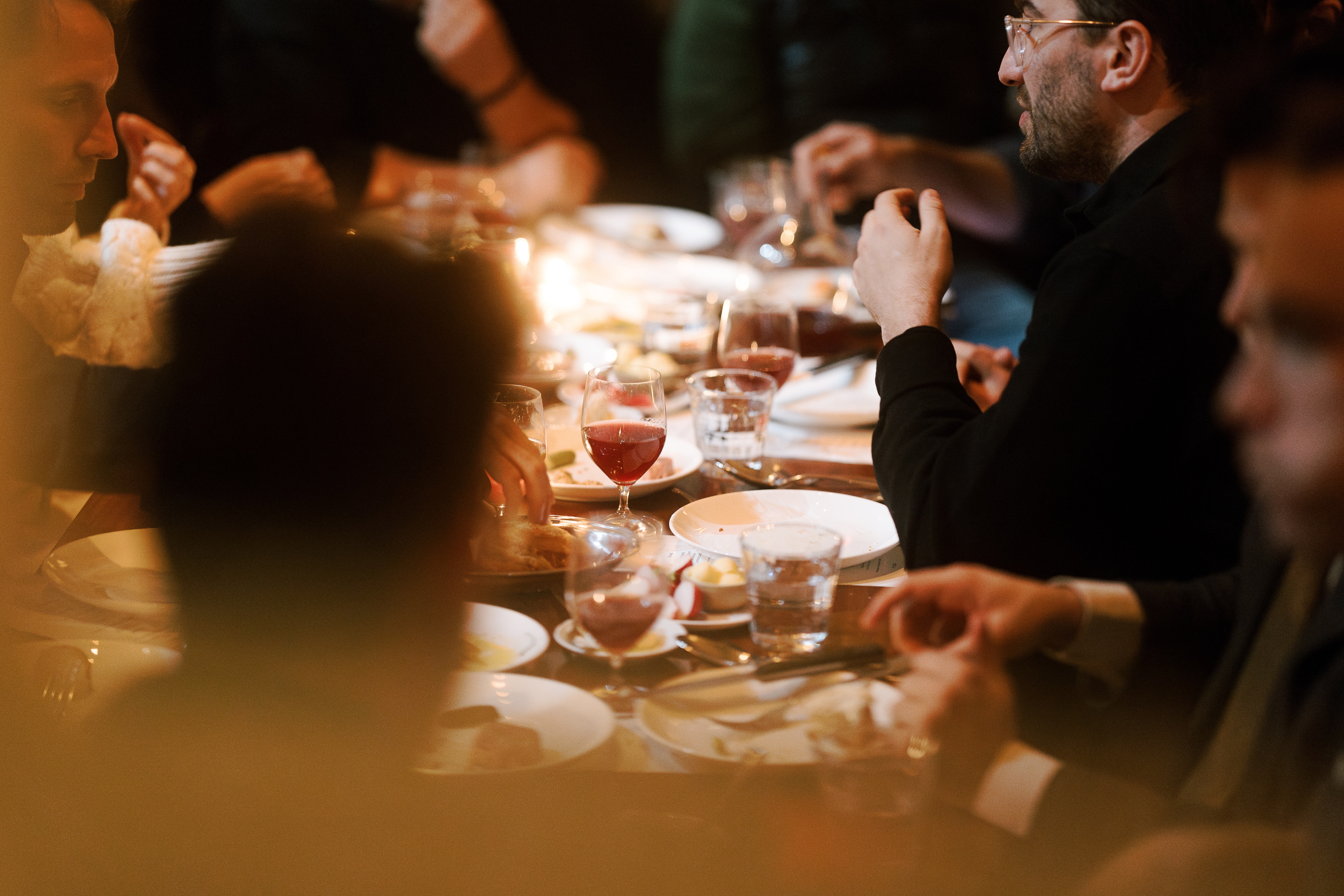 a group of people sitting at a table with wine glasses