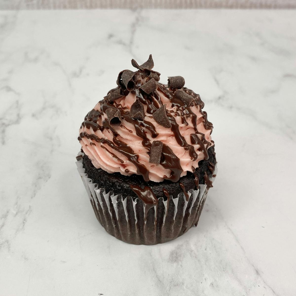 a chocolate cupcake on a table