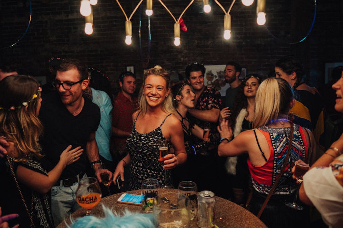 a group of people standing around a table