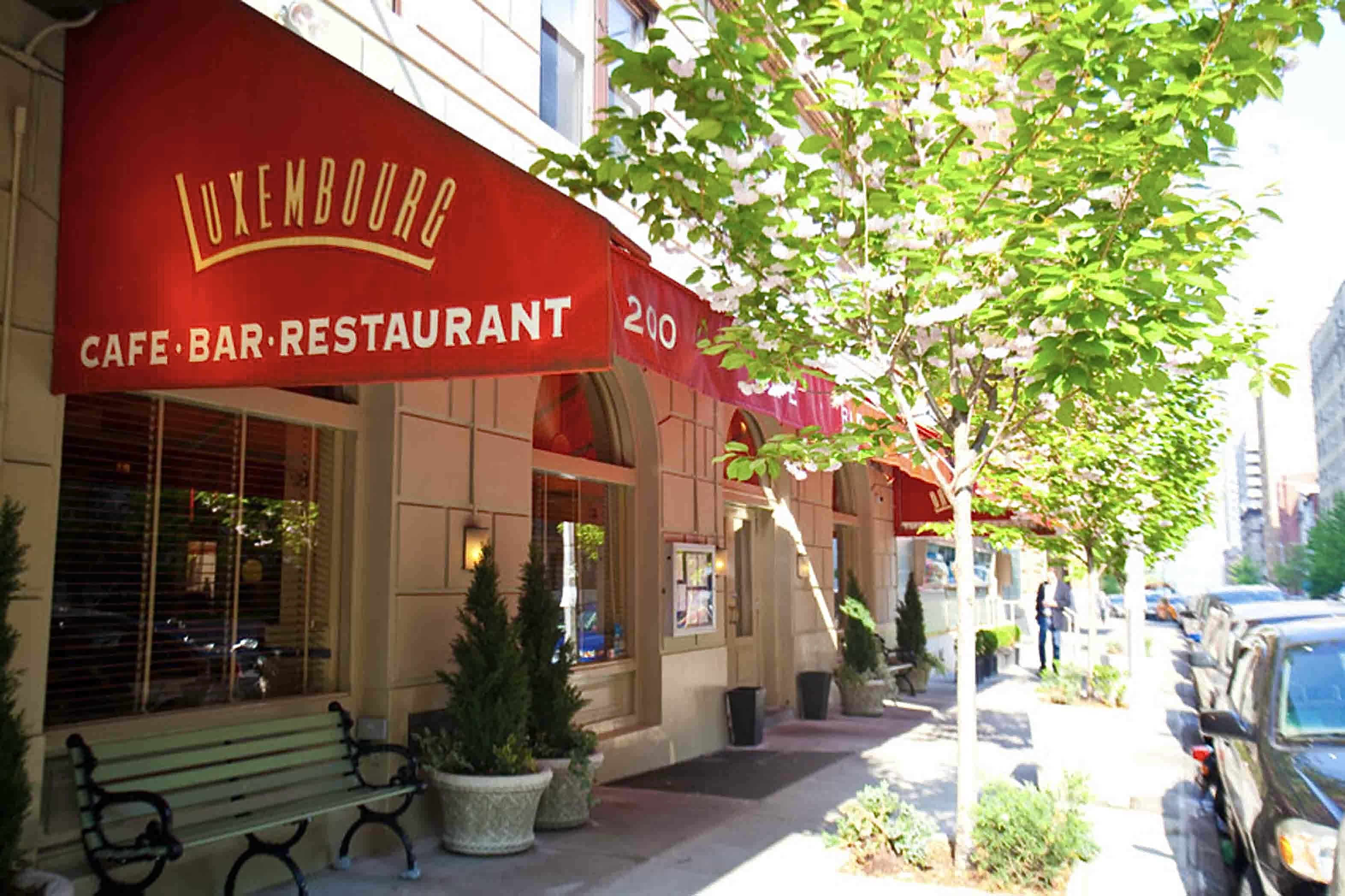 A vibrant red awning adorns the entrance of a charming restaurant, inviting guests to enjoy their dining experience