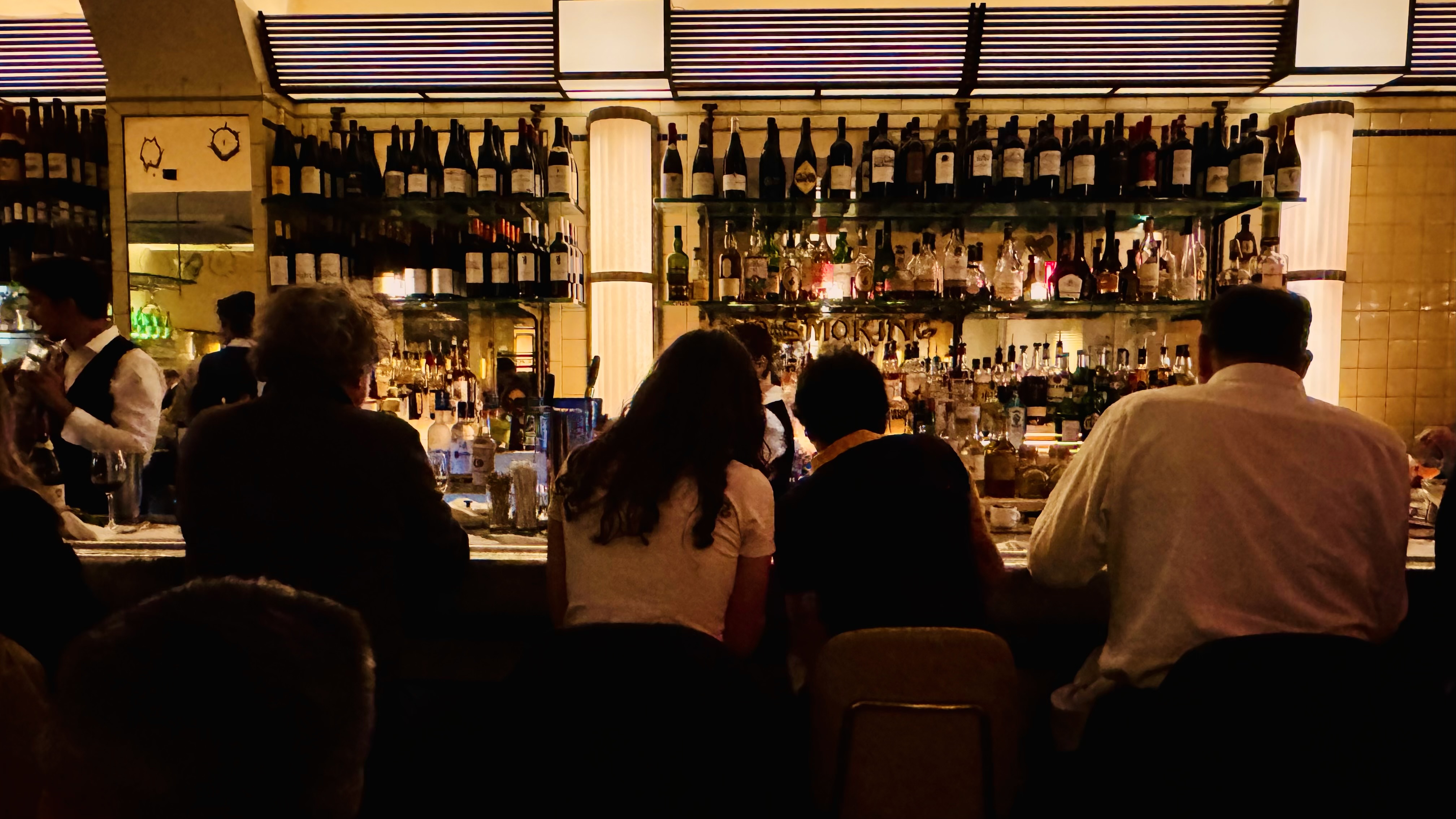 couple sitting at bar in low romantic lighting