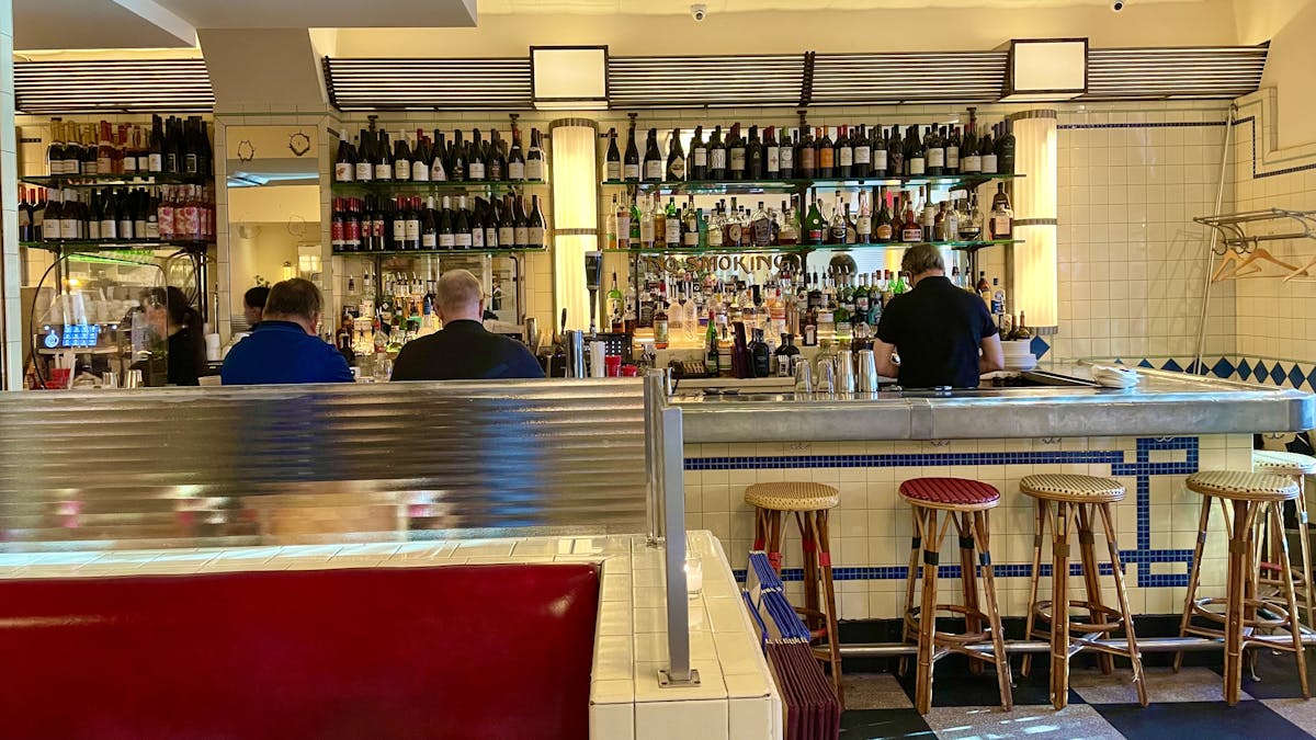 a group of people sitting at a table in a restaurant