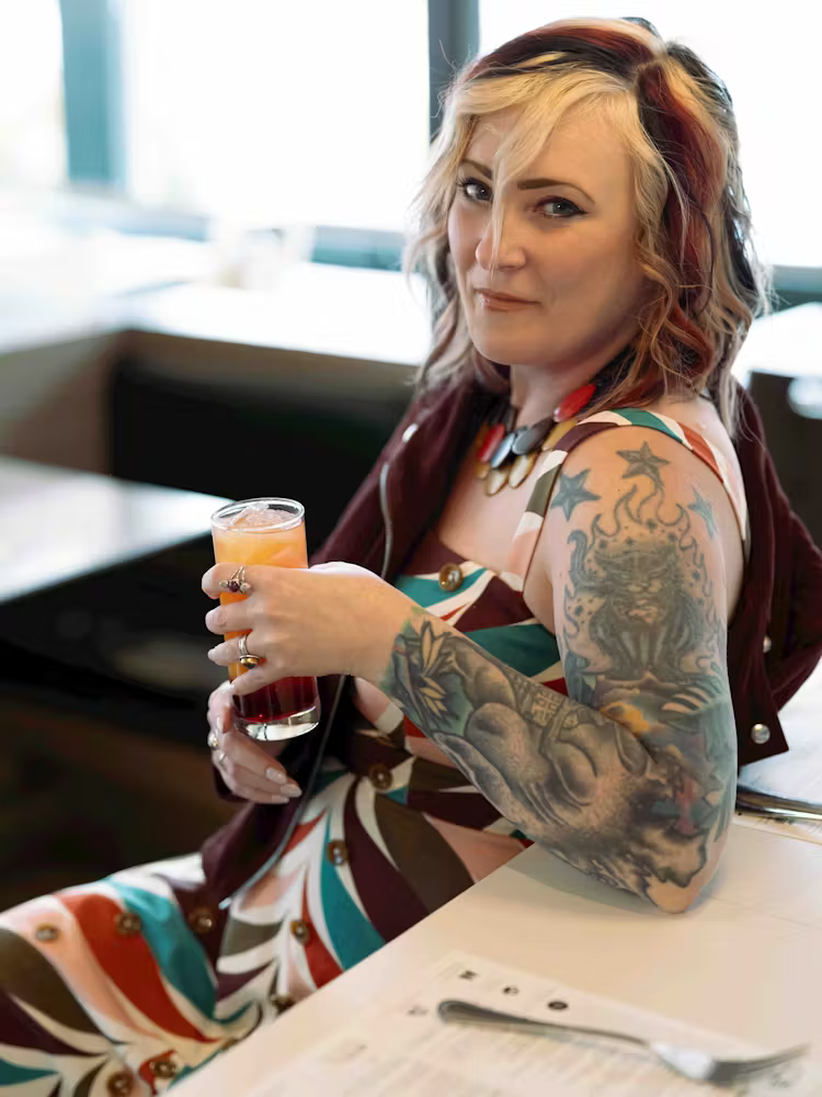 a woman sitting at a table eating food