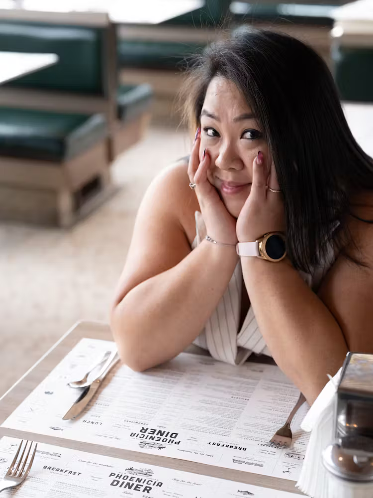 a woman sitting down talking on a cell phone