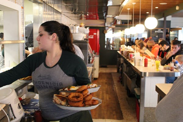 a person sitting at a table eating food