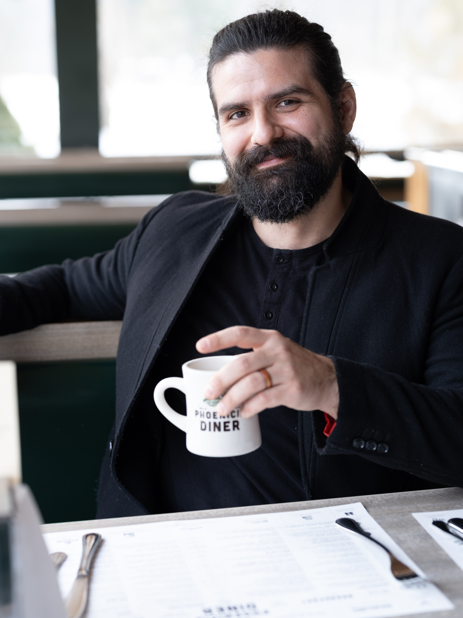 a man holding a cup of coffee