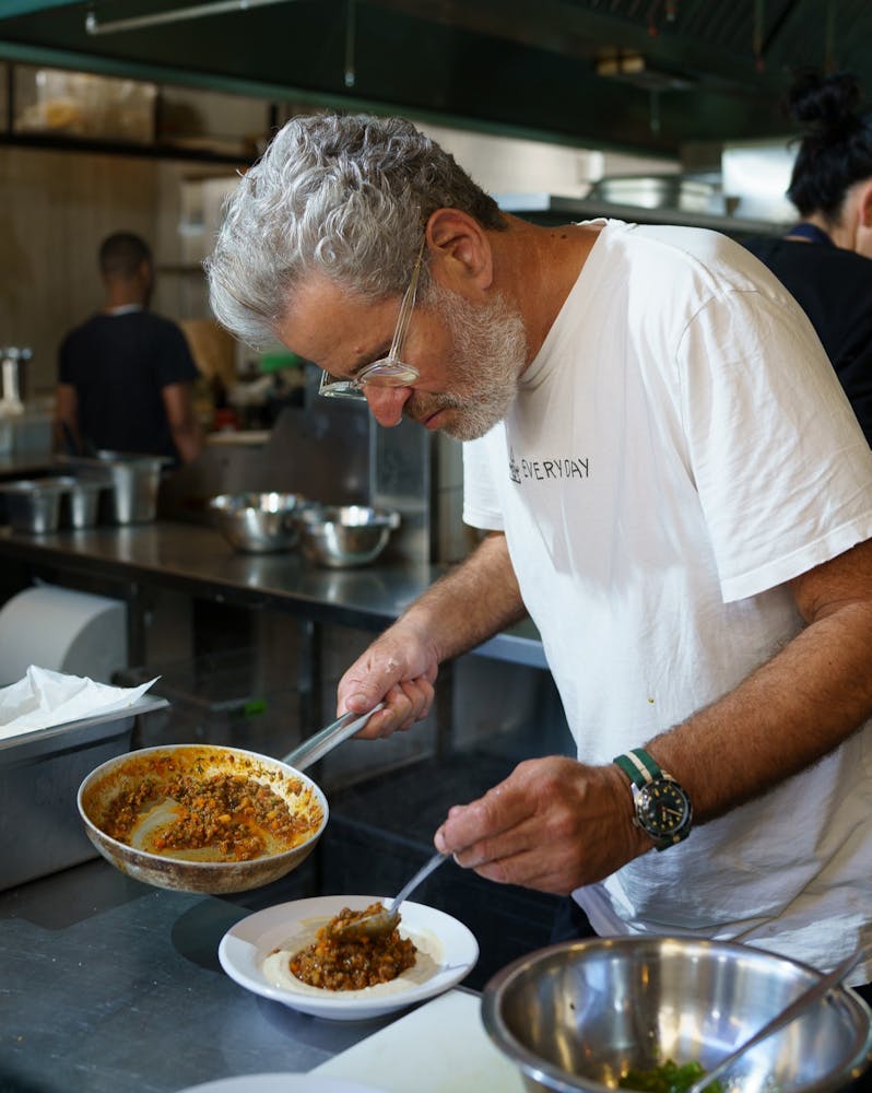 a man preparing food on a plate