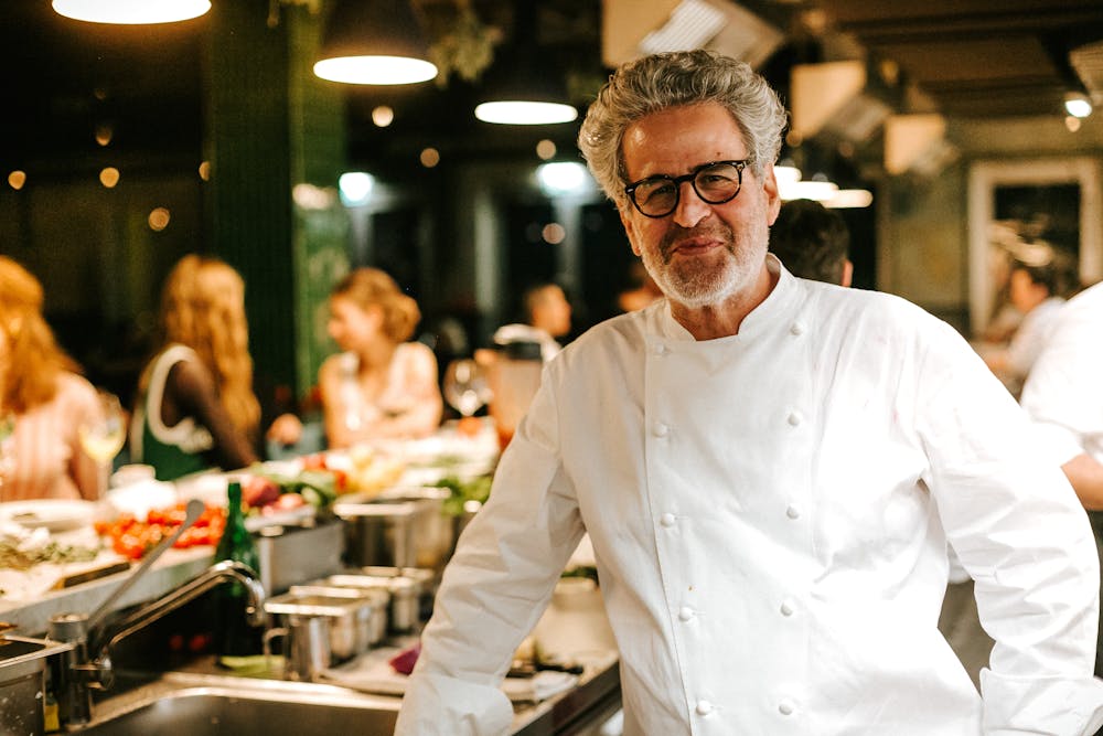 a man standing in a kitchen preparing food