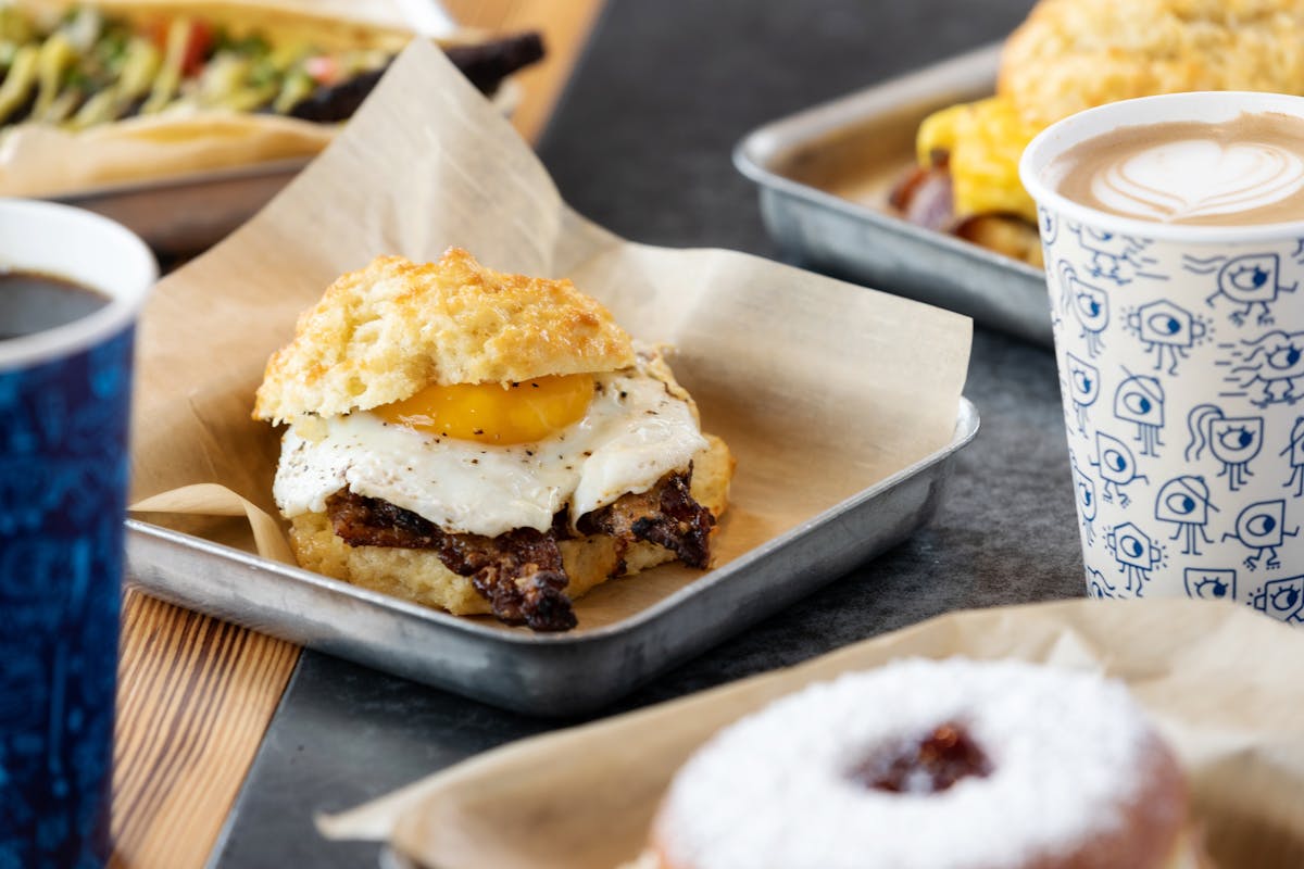 a close up of a plate of food and a cup of coffee