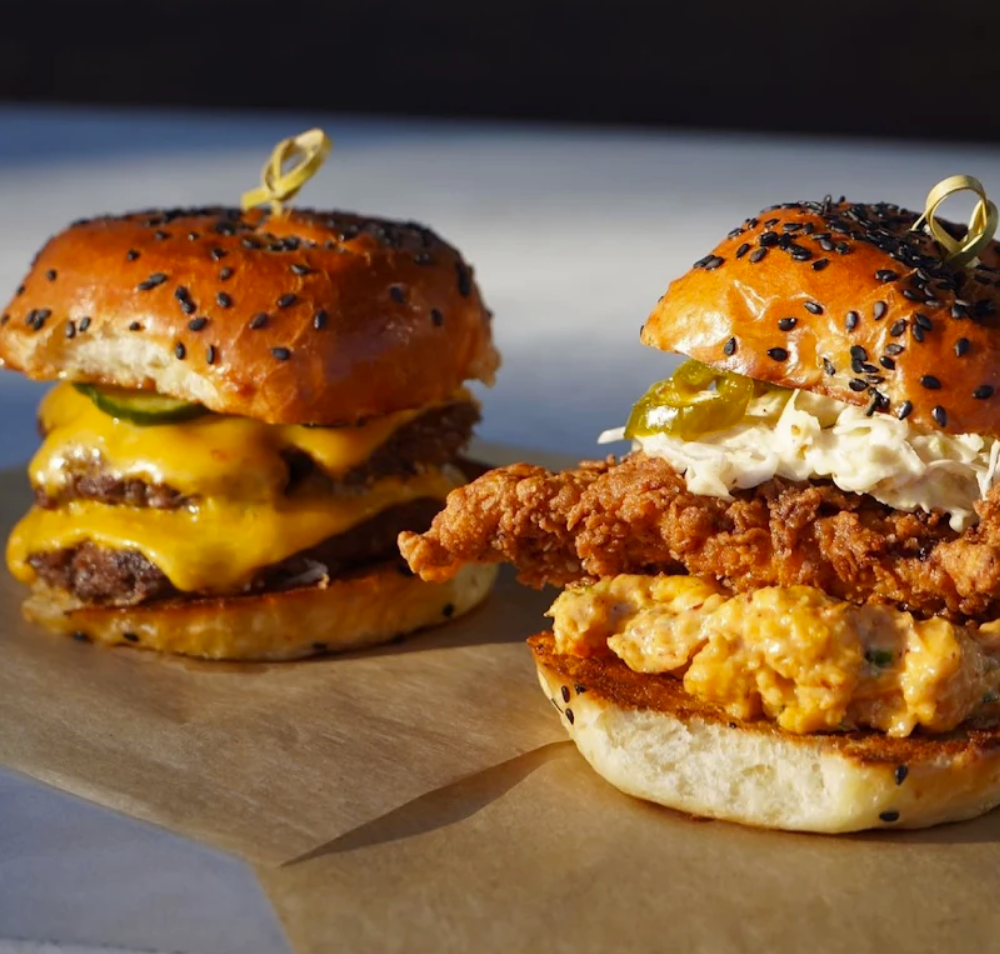 a two burgers on a paper