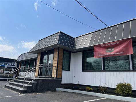 a house that has a sign on the side of a building