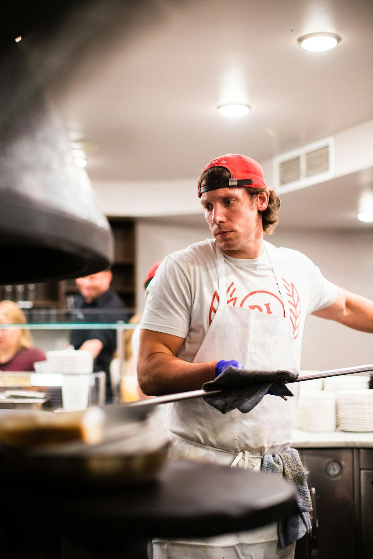 a man cooking in a kitchen preparing food