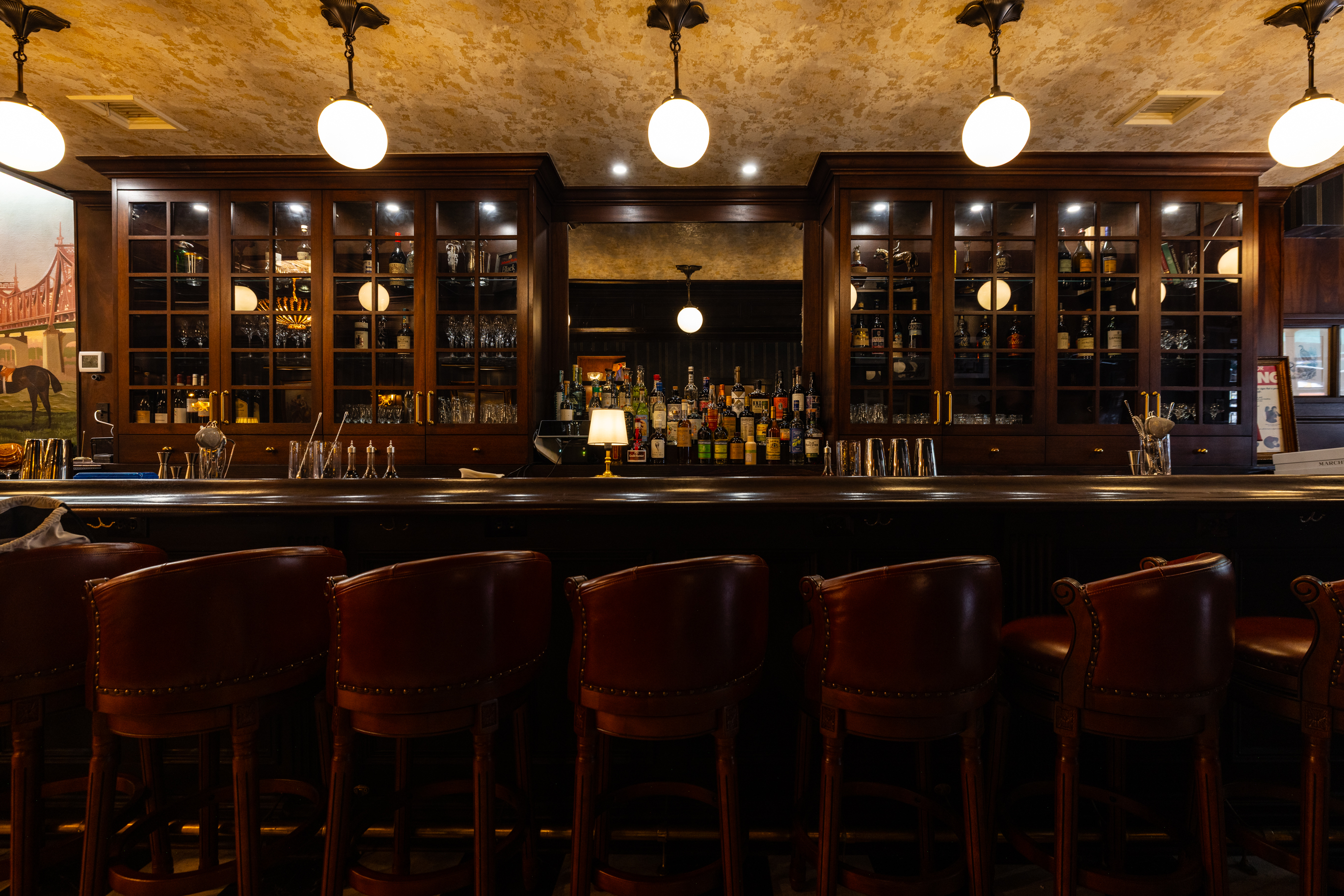 a bar with chairs and lights