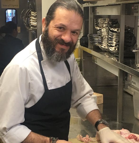 a man preparing food in a restaurant