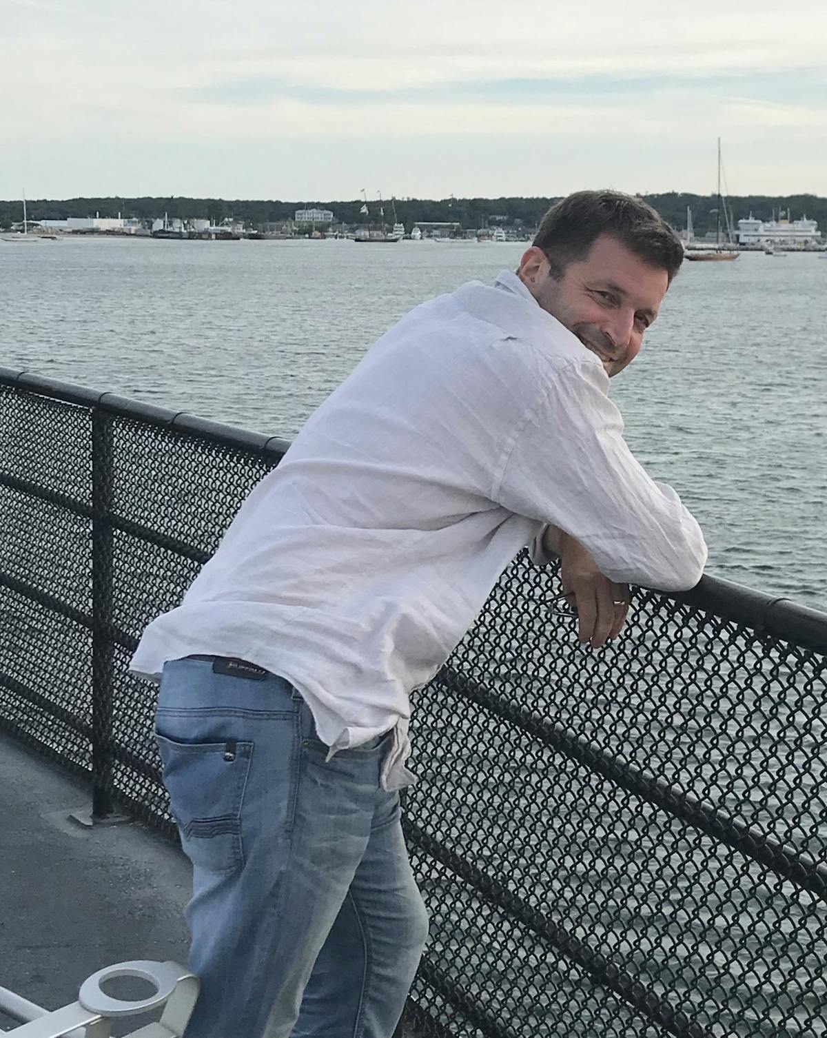a man standing next to a body of water