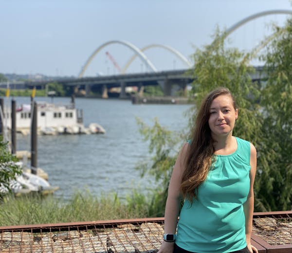 a woman standing in front of a river