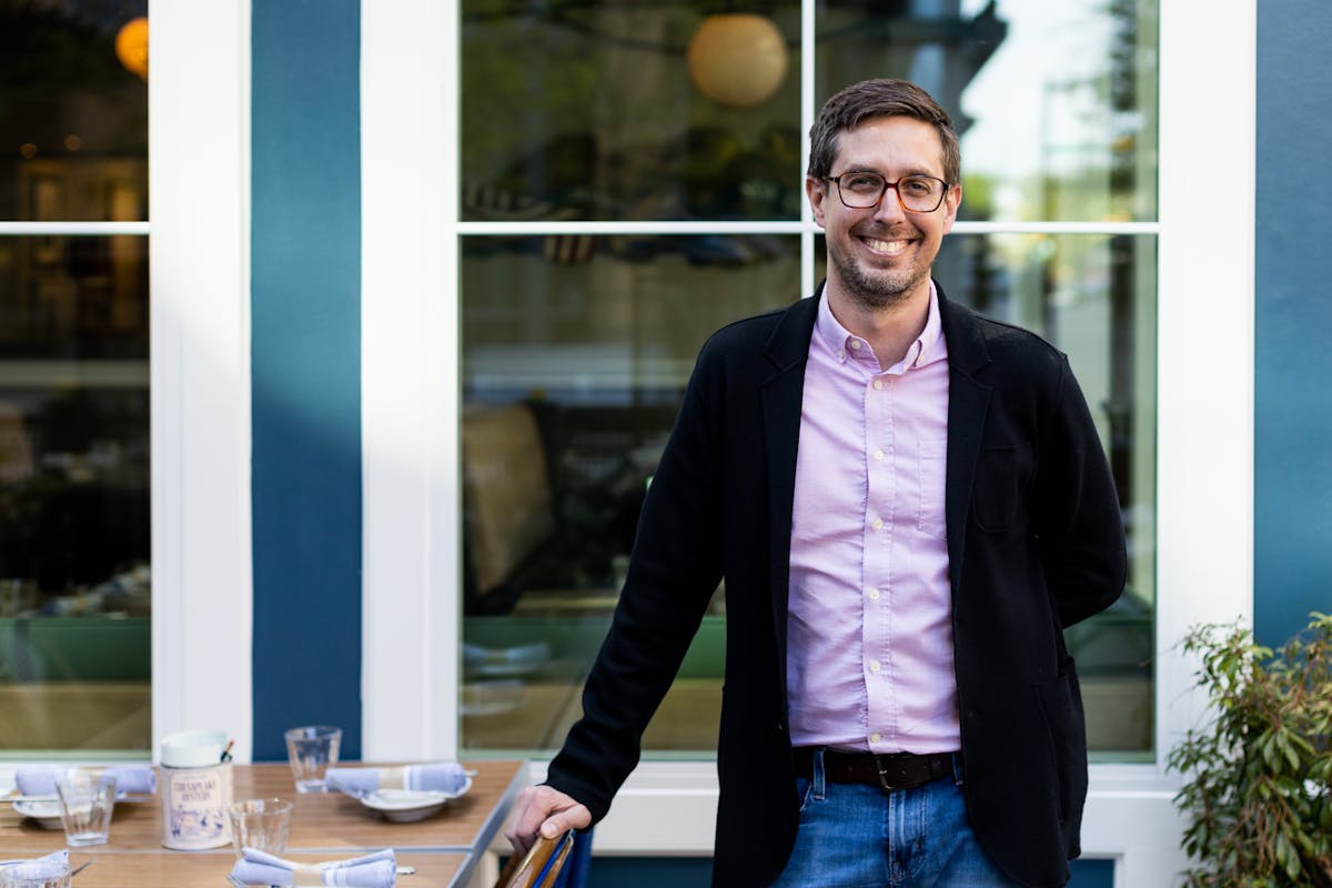 a man standing in front of a table