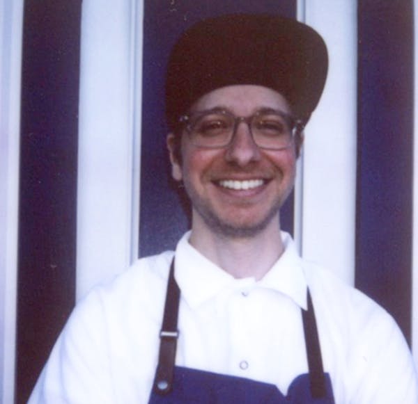 a person wearing a hat and smiling at the camera
