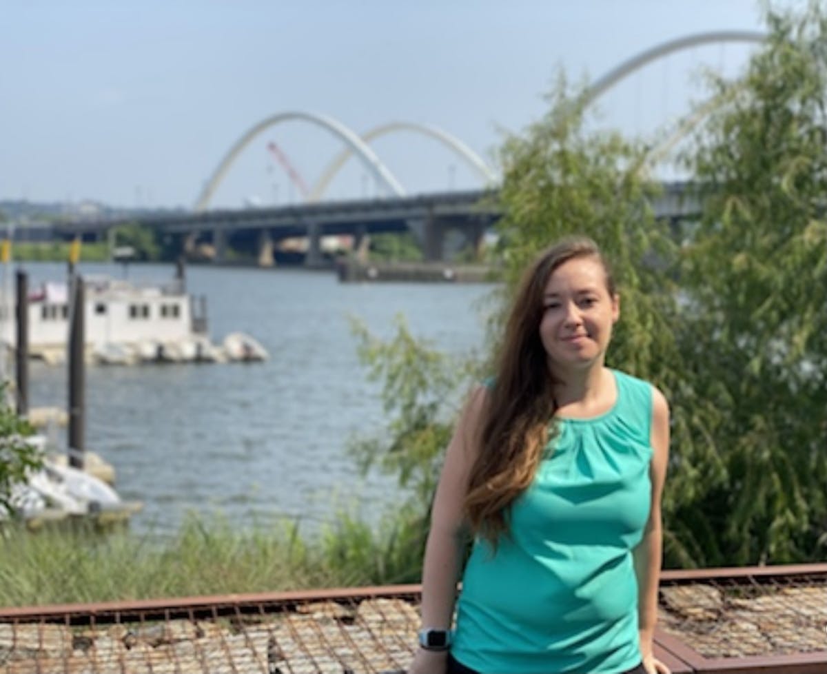 a woman standing next to a river