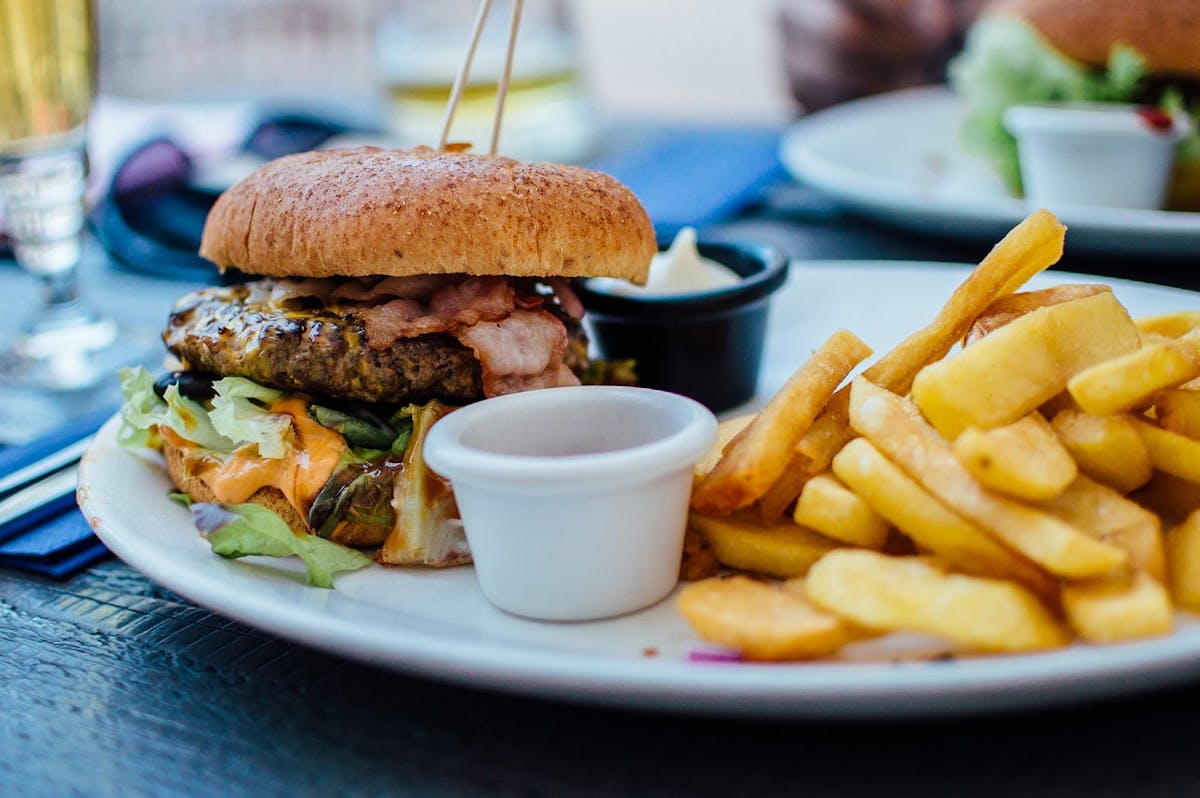 a close up of a plate of food and a cup of coffee