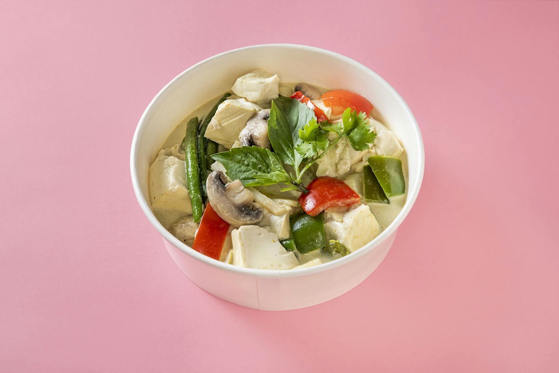 a bowl of noodles topped with veggies