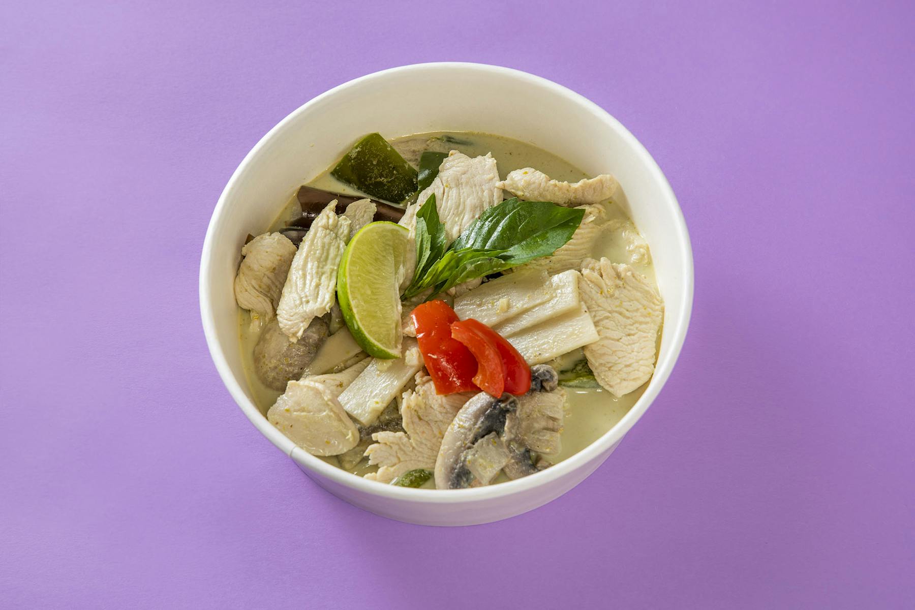 a bowl of noodles topped with veggies