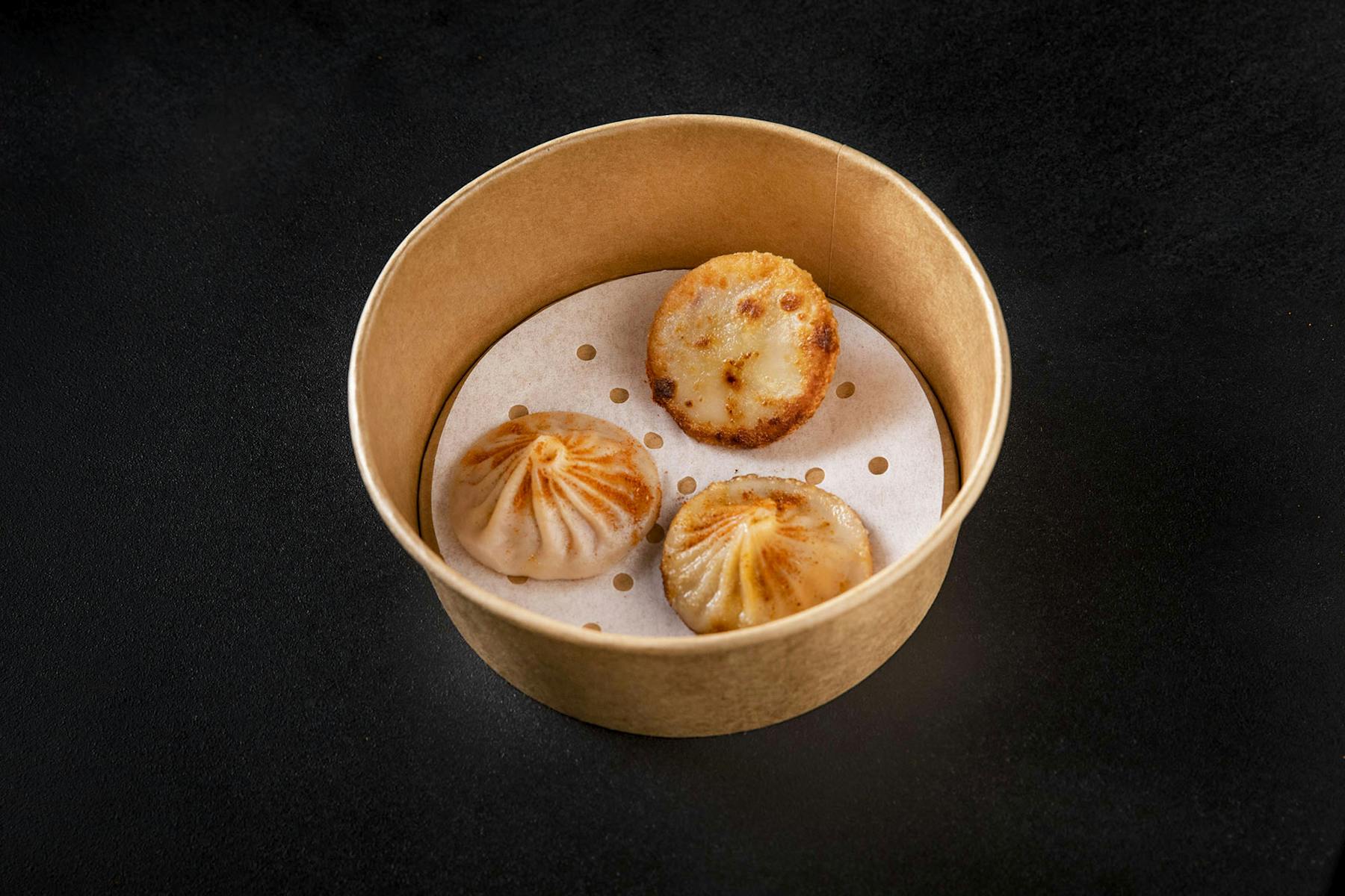 a wooden bowl with mochi inside of it