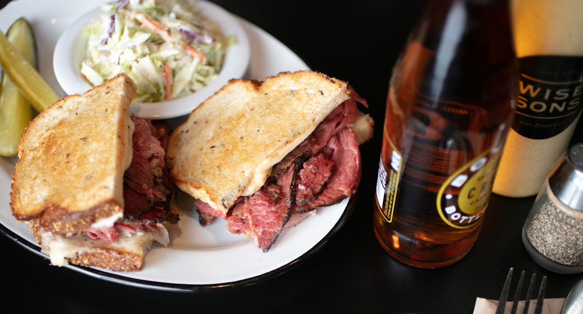 a plate of food and a bottle on a table
